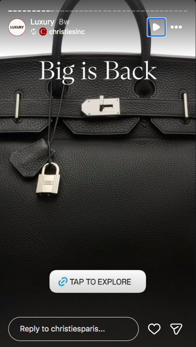 A black Hermes Birkin bag in grained-leather with a silver padlock and key.