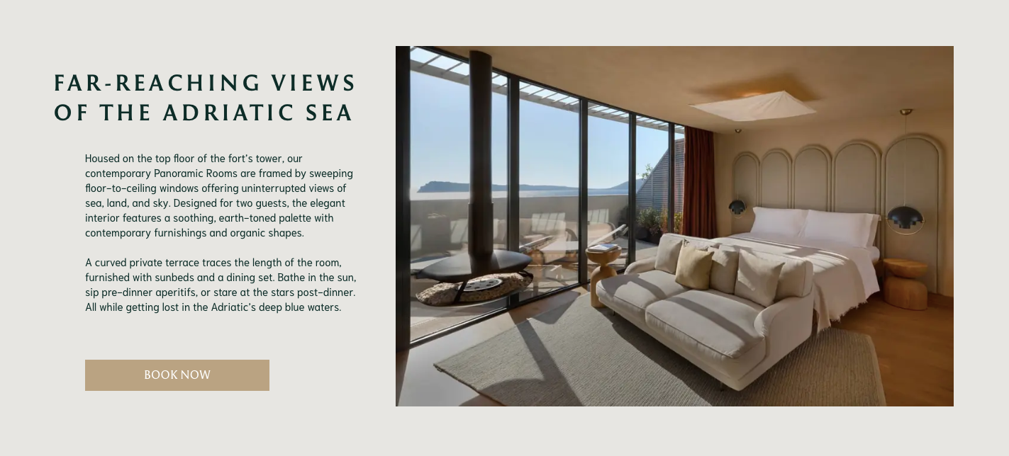 A design-led Banyan Tree hotel room with understated interiors and windows that look out onto a terrace with sea views and blue skies.