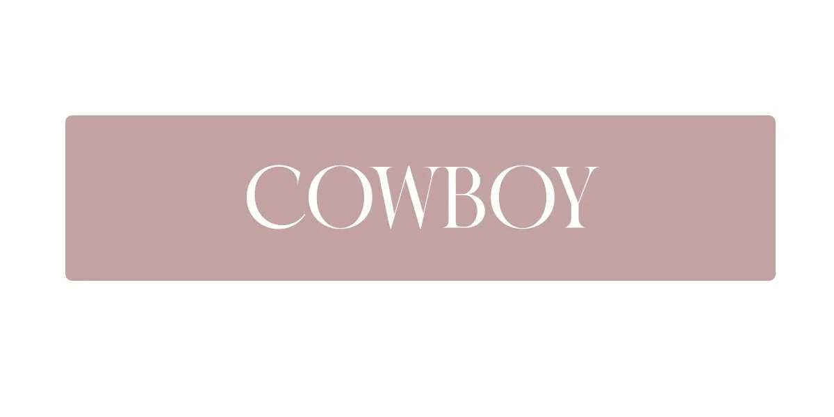 A beige rectangular button with rounded corners and the word 'COWBOY' written in white capital letters.