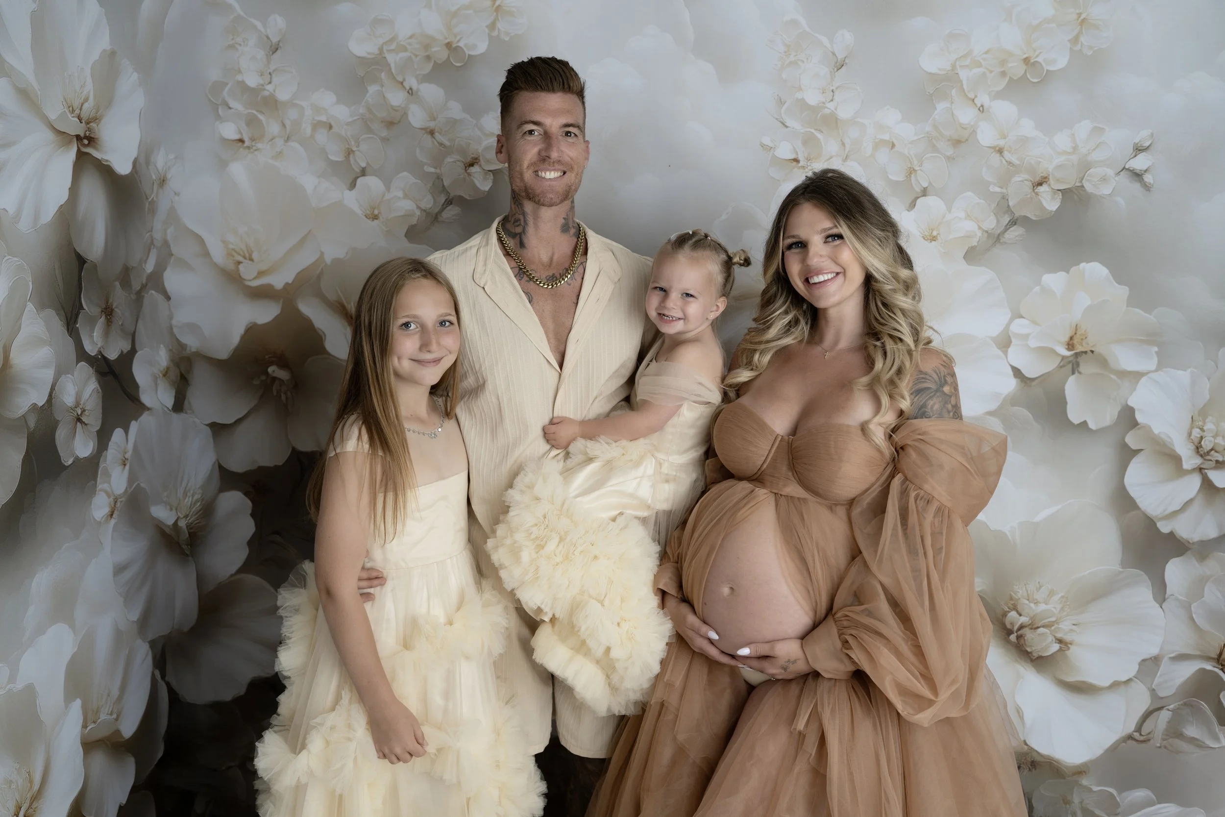 Capture the beauty of motherhood with our maternity photography. Choose outdoor or studio sessions, with partner and children welcome. Enjoy access to our client closet featuring stunning dresses, fabrics, backdrops, and accessories for a variety of 