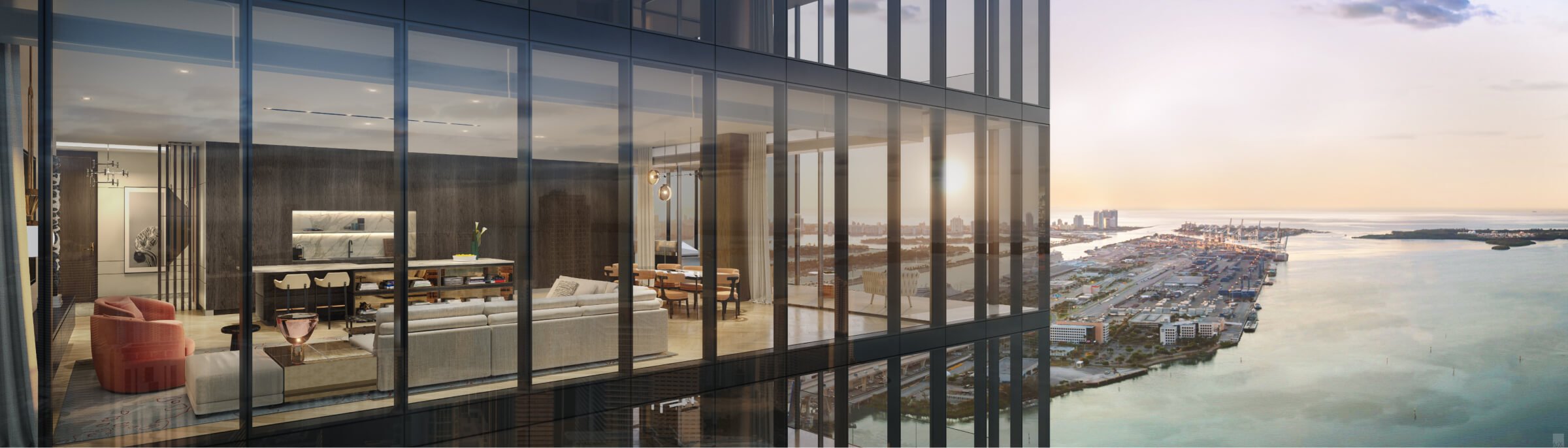 Interior view of a modern, glass-walled apartment with a view of a coastal cityscape during sunset. The room features contemporary furniture including sofas, chairs, and a dining area.