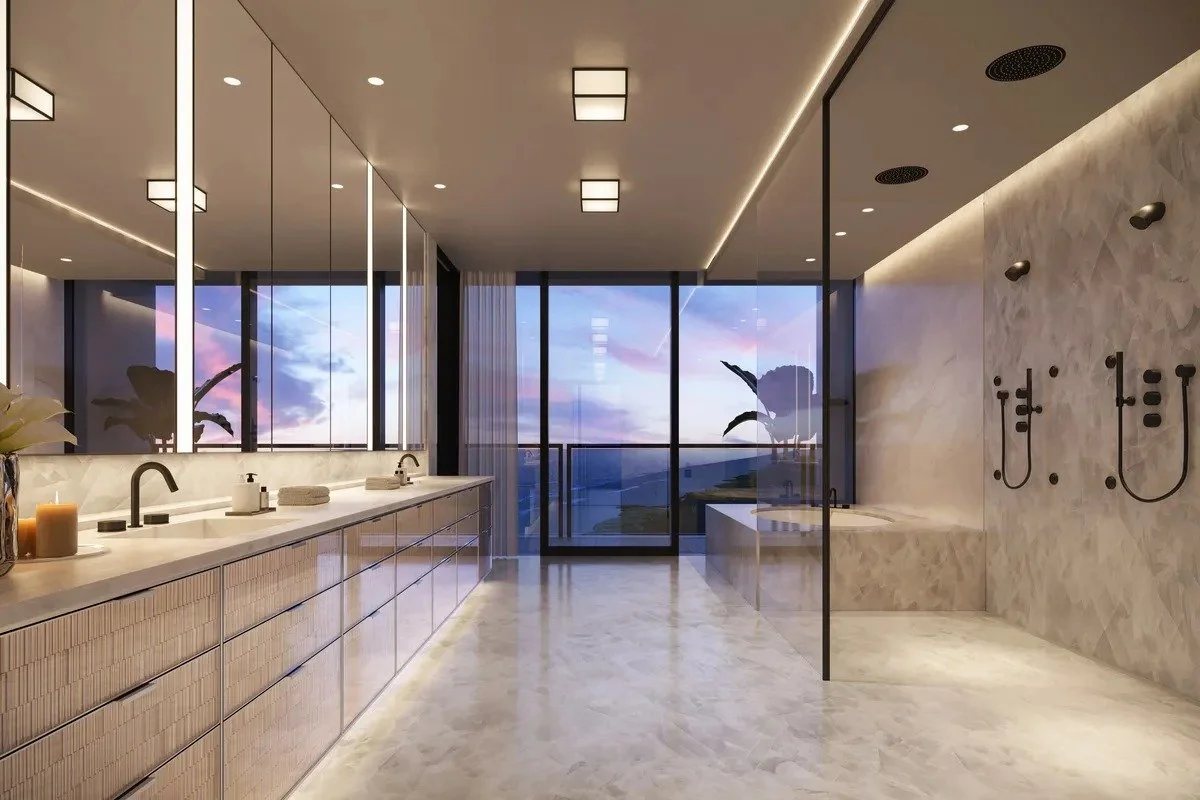 Luxurious modern bathroom with double sinks, large mirrors, glass shower, panoramic window view, marble flooring, and recessed lighting.
