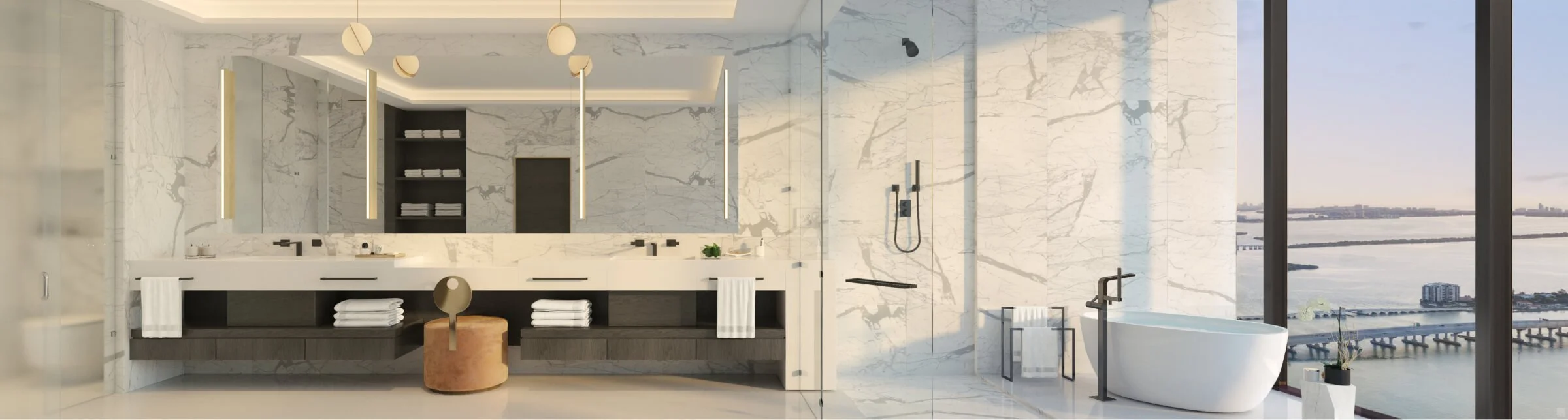 Luxurious modern bathroom with marble walls, a large mirror, and a freestanding bathtub. Large windows offer a view of the ocean and cityscape. Contemporary design with sleek fixtures.