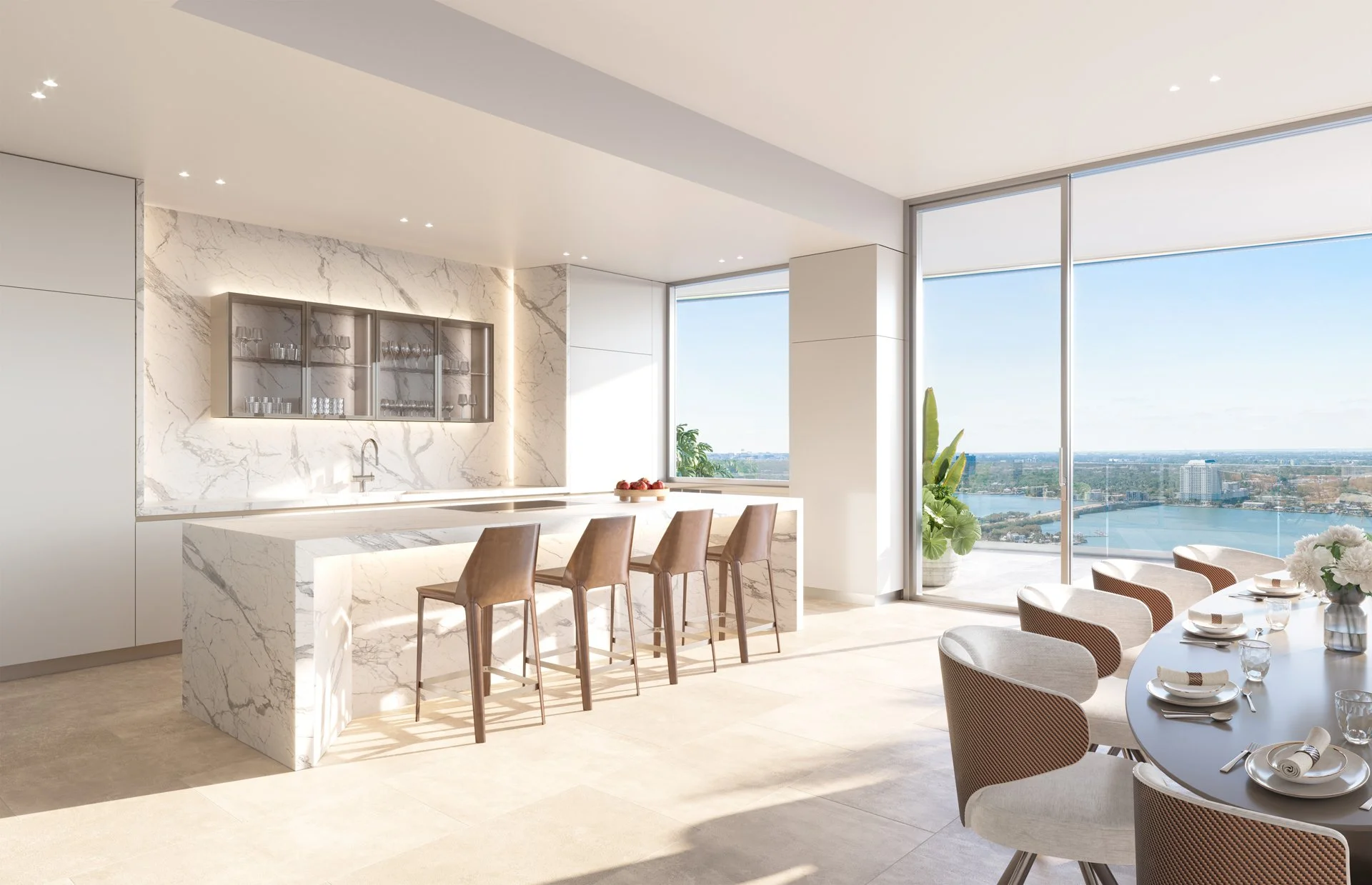 Modern kitchen and dining area with marble island, bar stools, glass cabinets, and large windows overlooking water view.