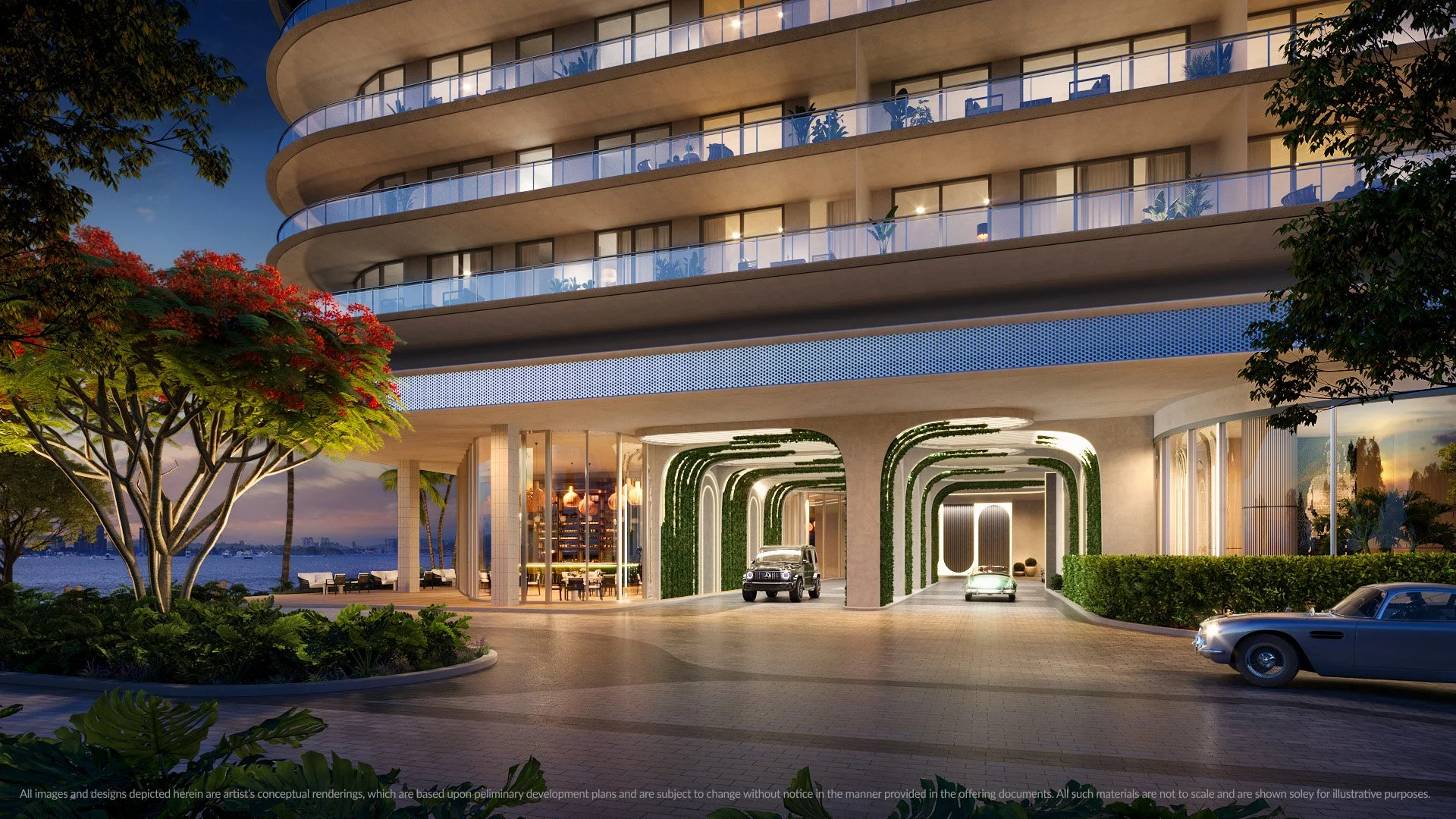 Luxury building entrance with modern architectural design, illuminated archways, cars parked in driveway, and lush landscaping with red-flowered trees.