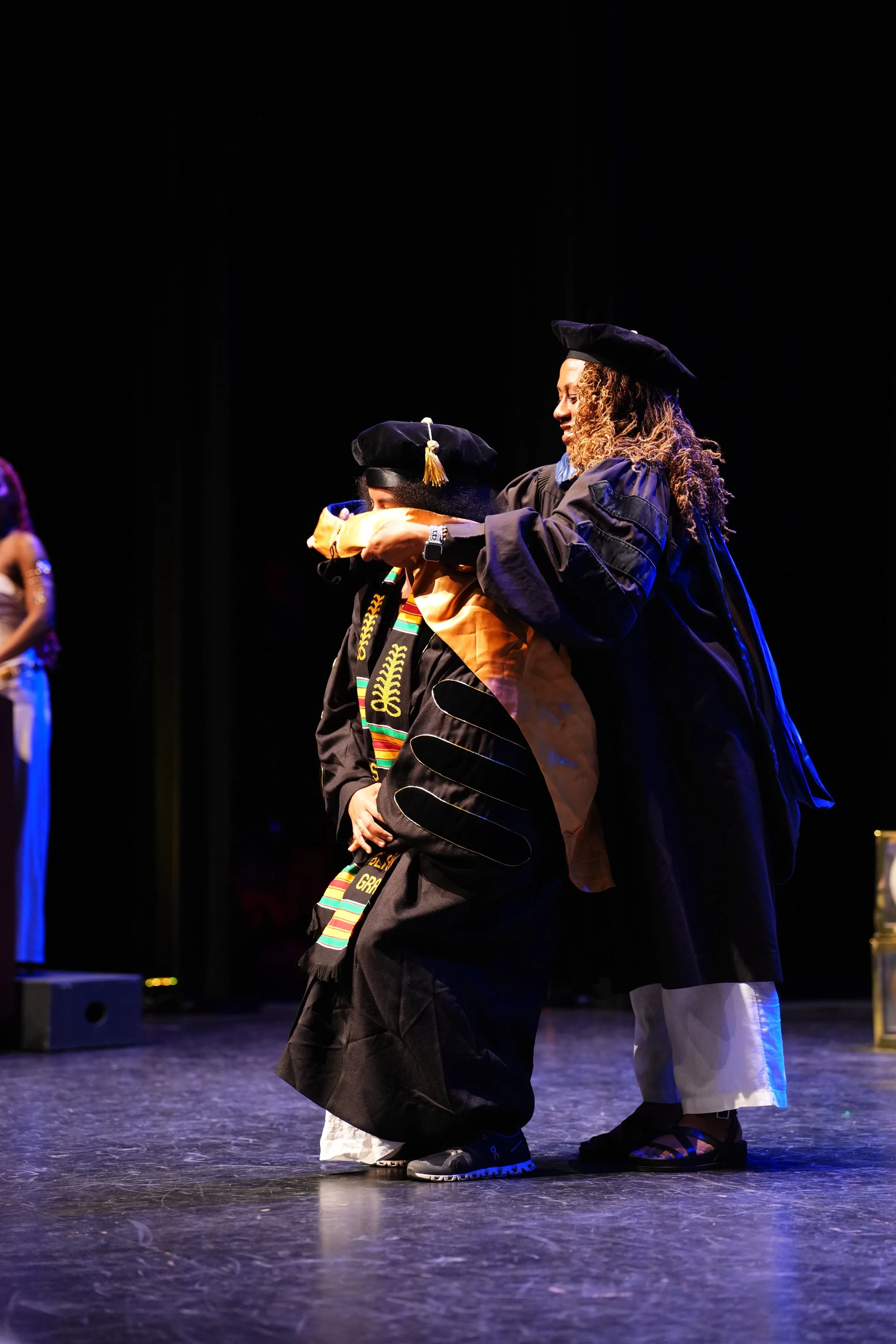 Black Graduation, Dr.Solaire Denaud hooded by Dr.Meredith Merchant, at UCSB