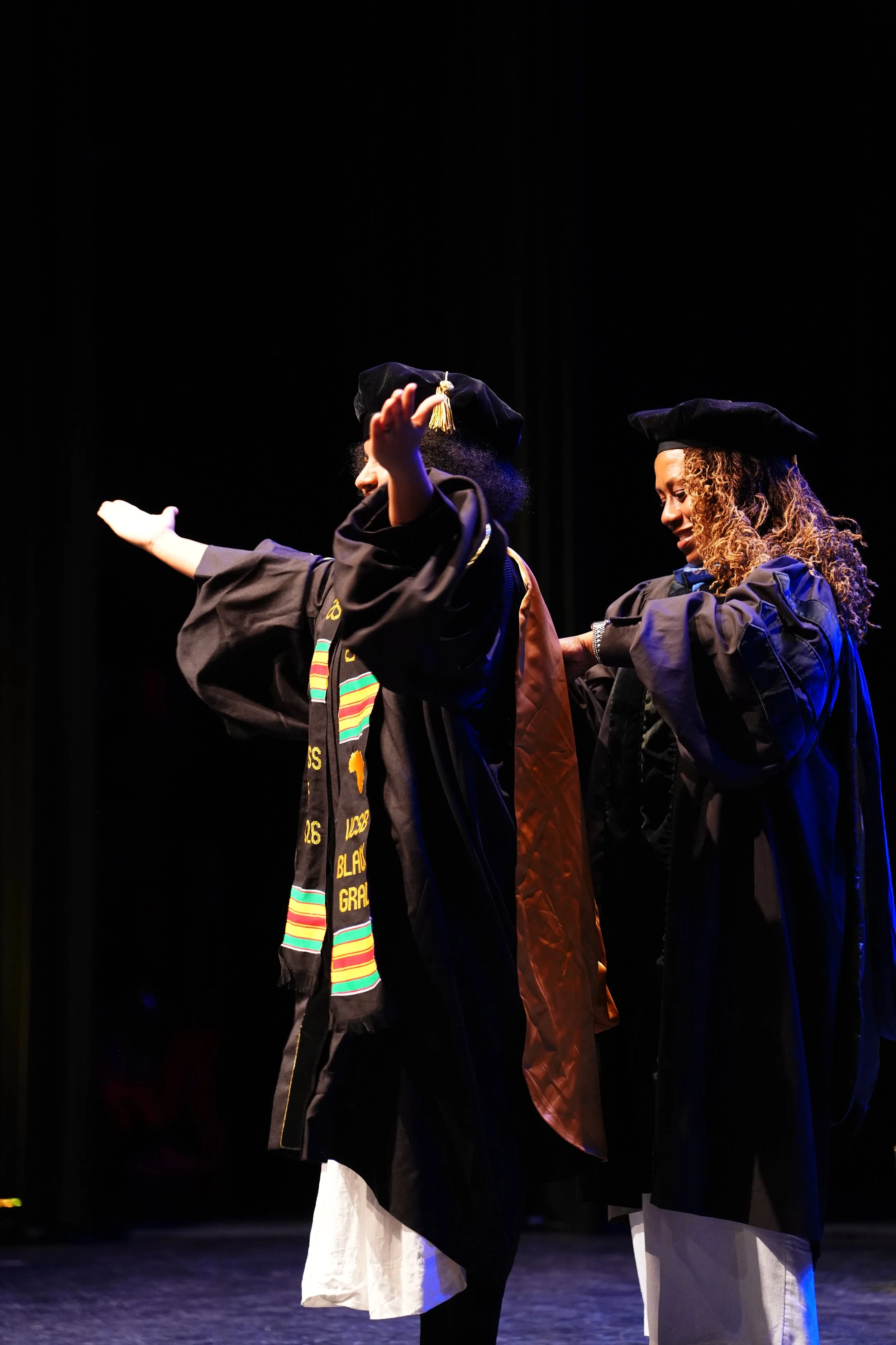 Black Graduation, Dr.Solaire Denaud hooded by Dr.Meredith Merchant, at UCSB