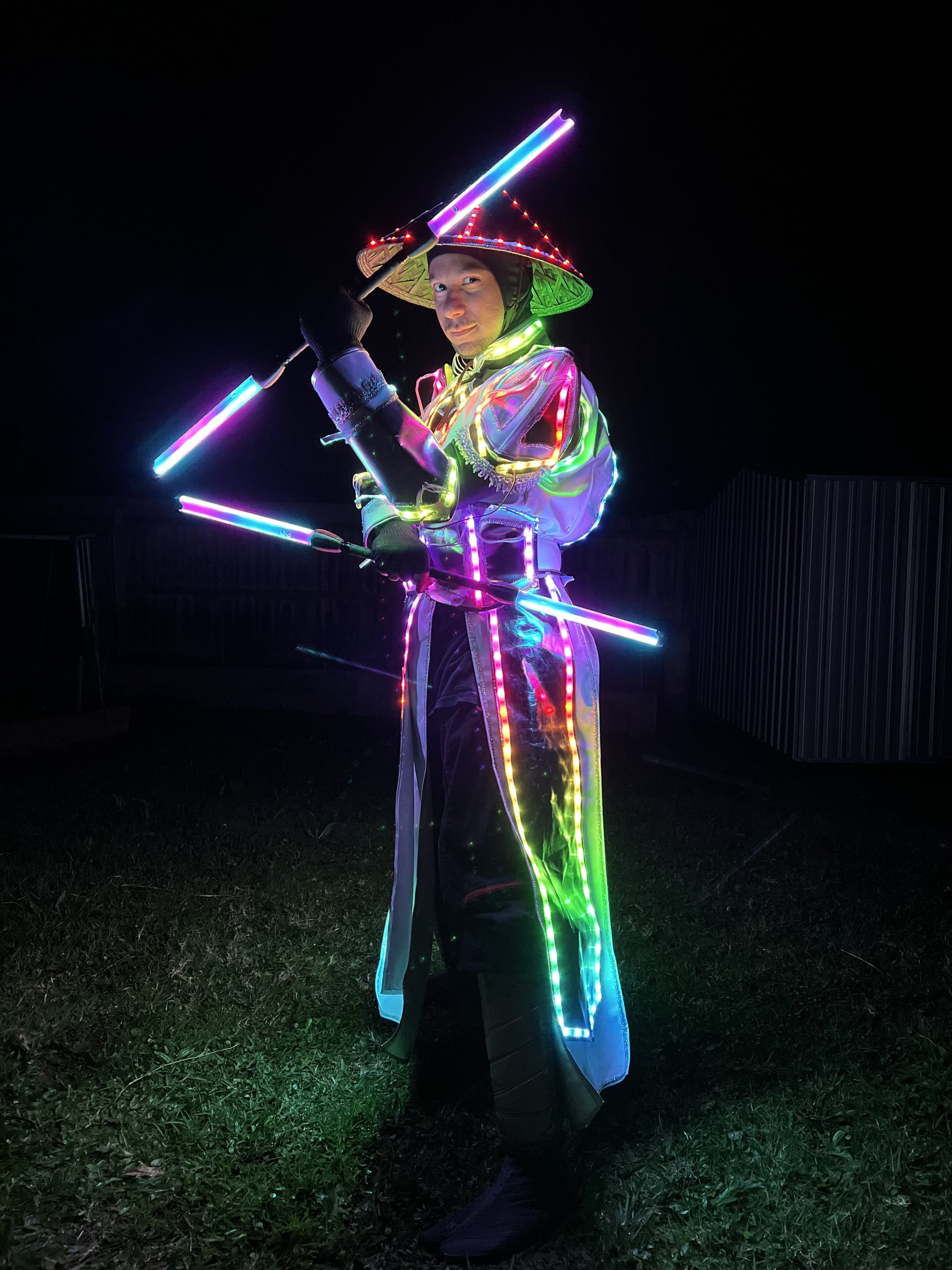 A man in bright LED suit holding LED staff