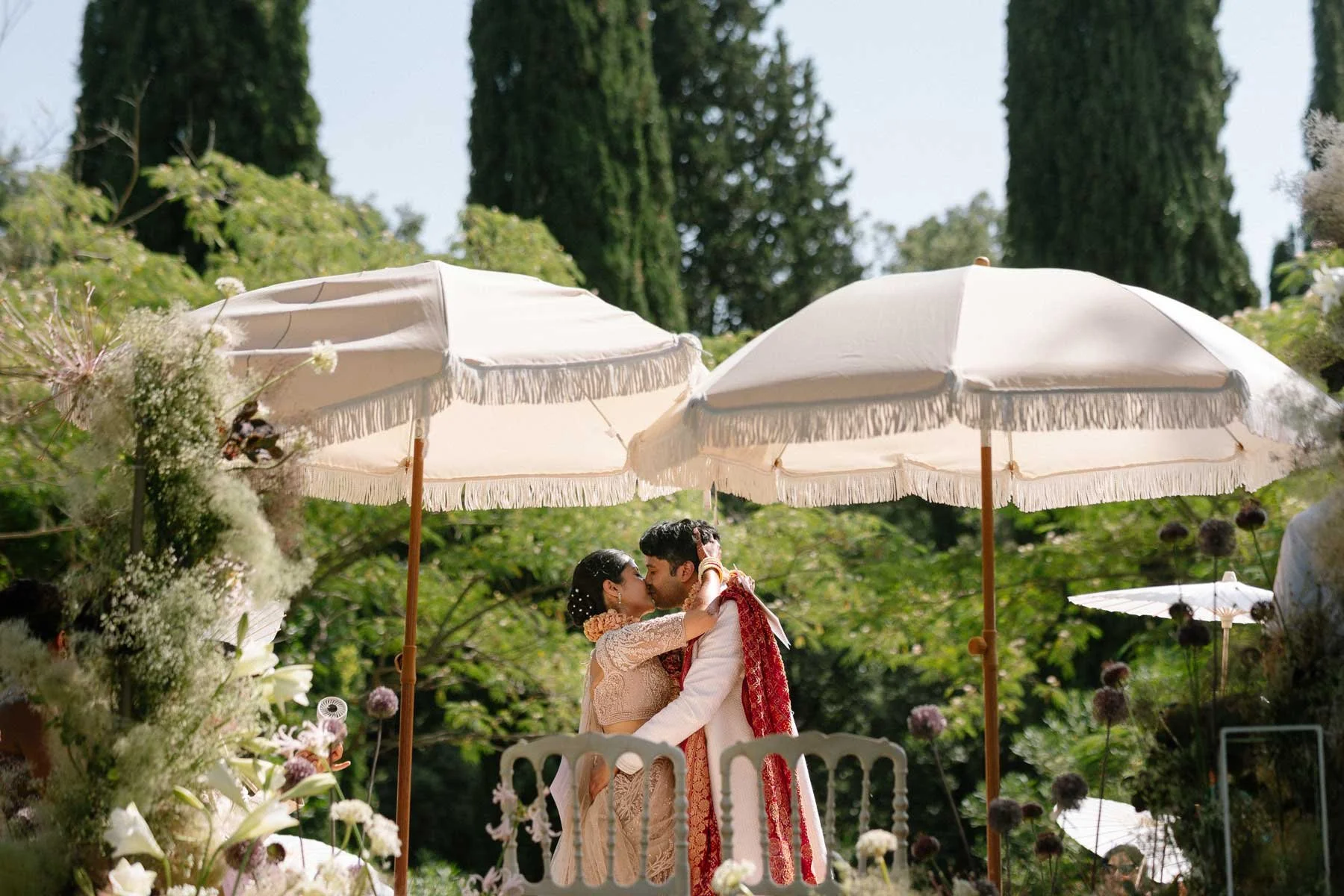 a couple kiss at their Indian Wedding at Masia Egara