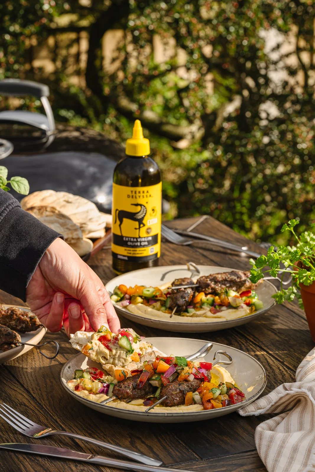Terra Delyssa BBQ lamb kofta, with hand, WEB.jpg