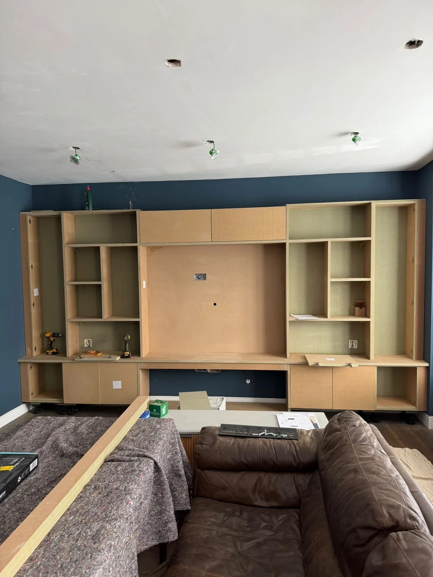In progress: TV joinery with shelves and cupboards being fitted in the sitting room