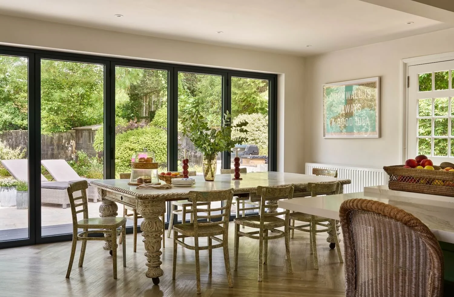 Dining table, chairs and bifold doors