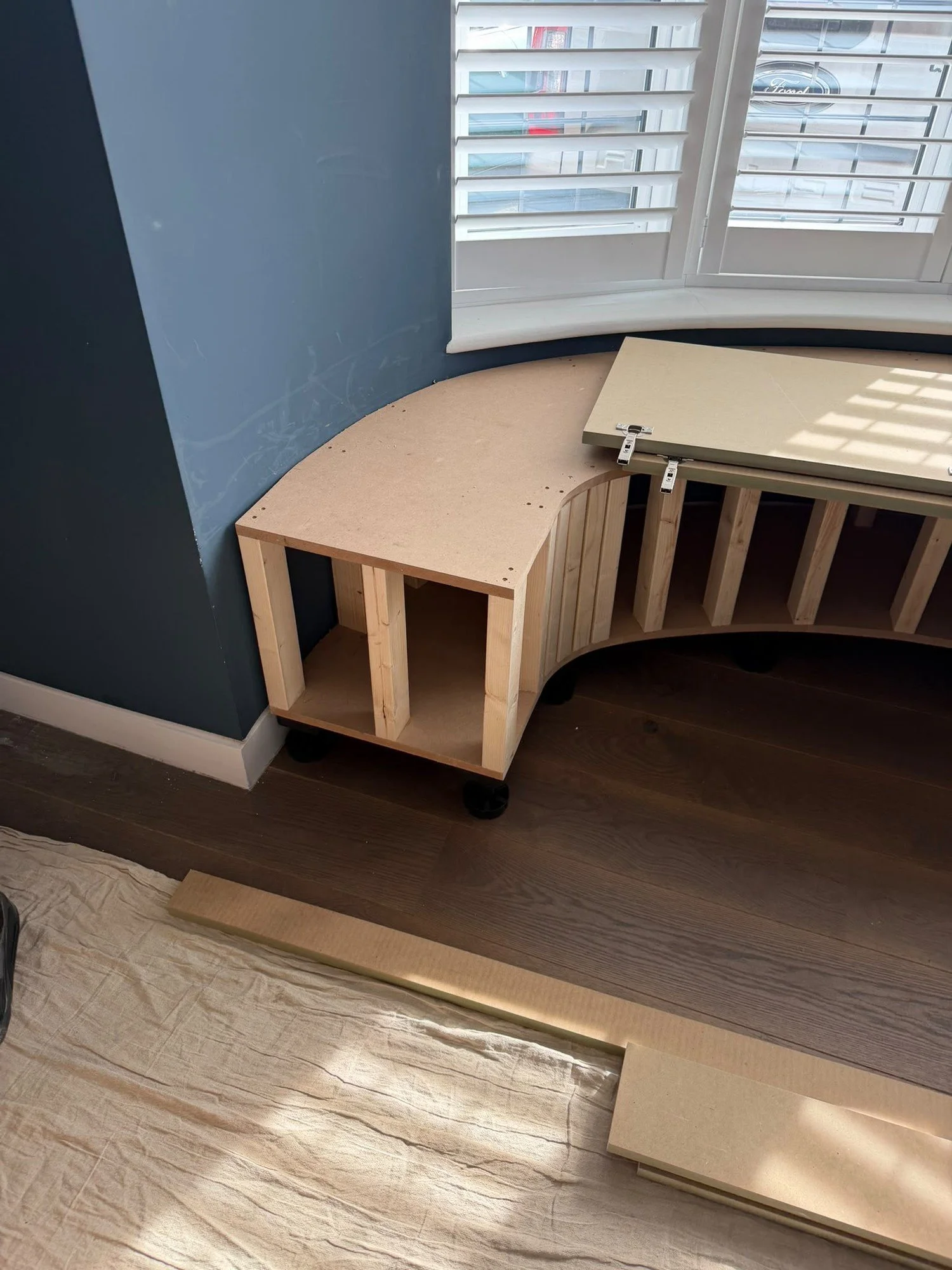 In progress: the frame of the curved window seat being built in the bay