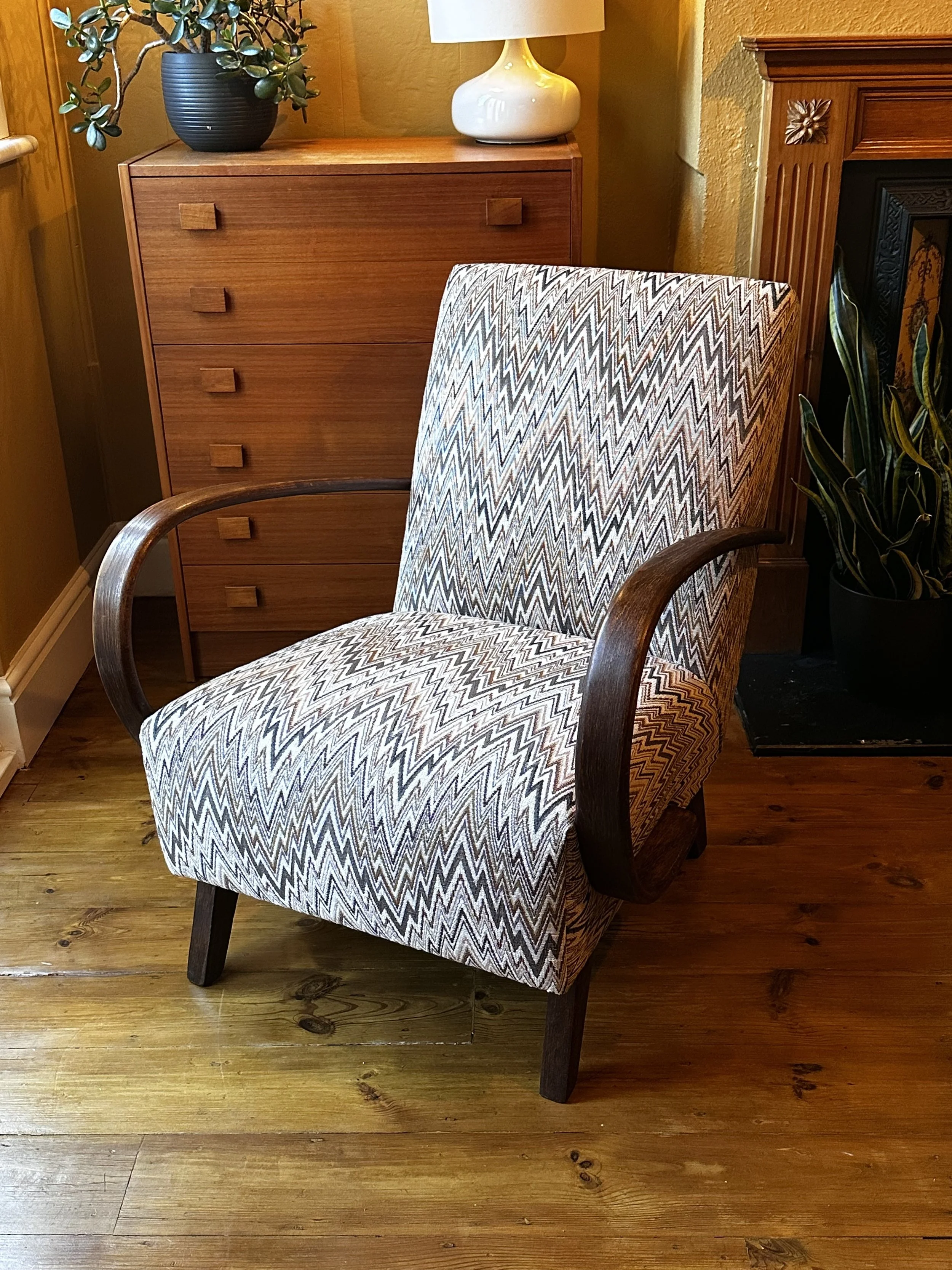 Art Deco Halabala armchair upholstered in ROMO Izara fabric in Cajun, with curved wooden armrests.