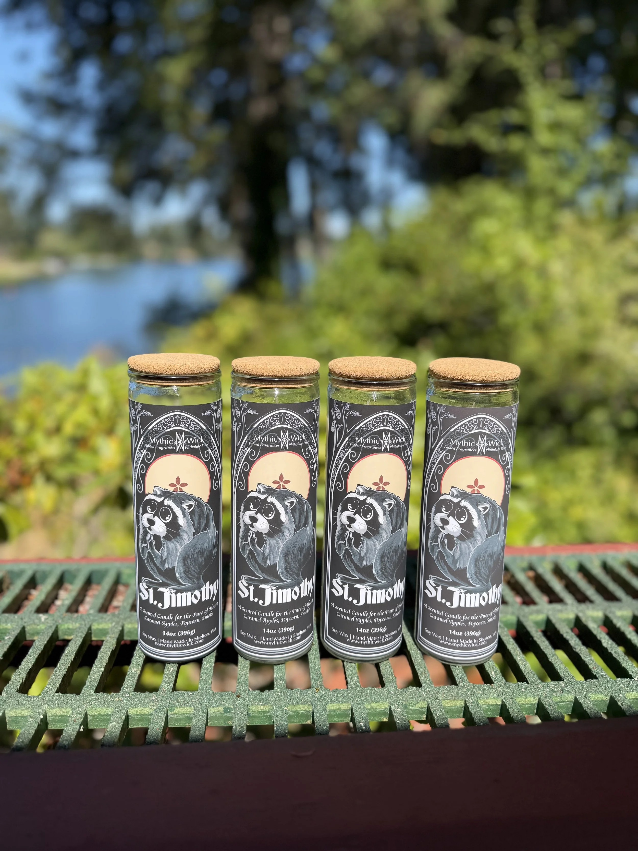 Tall altar candles with a drawing of Jimothy Raccoon