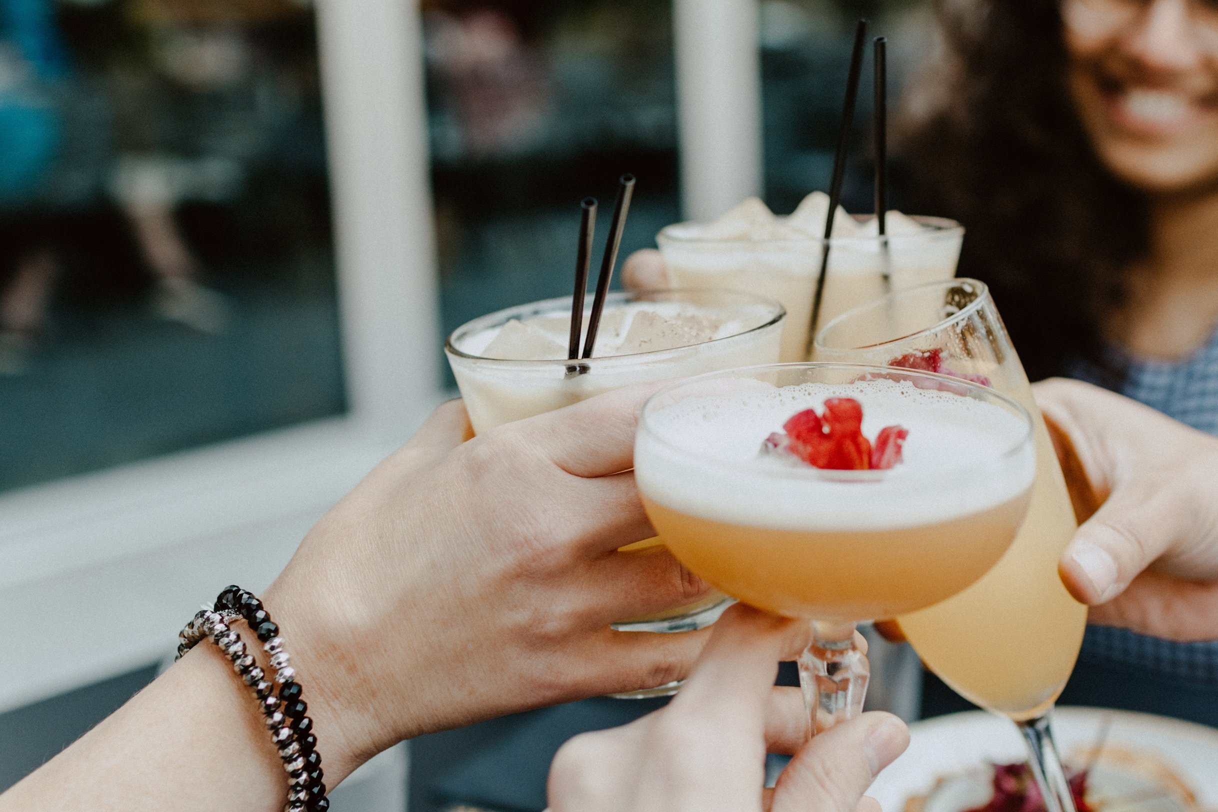 a group of girl cheersing drinks