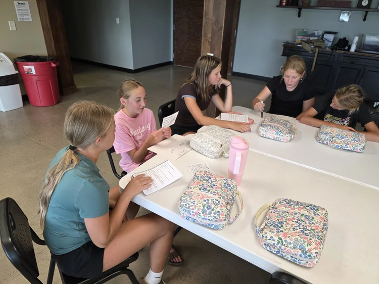 Students at a table with their Bibles during a study session