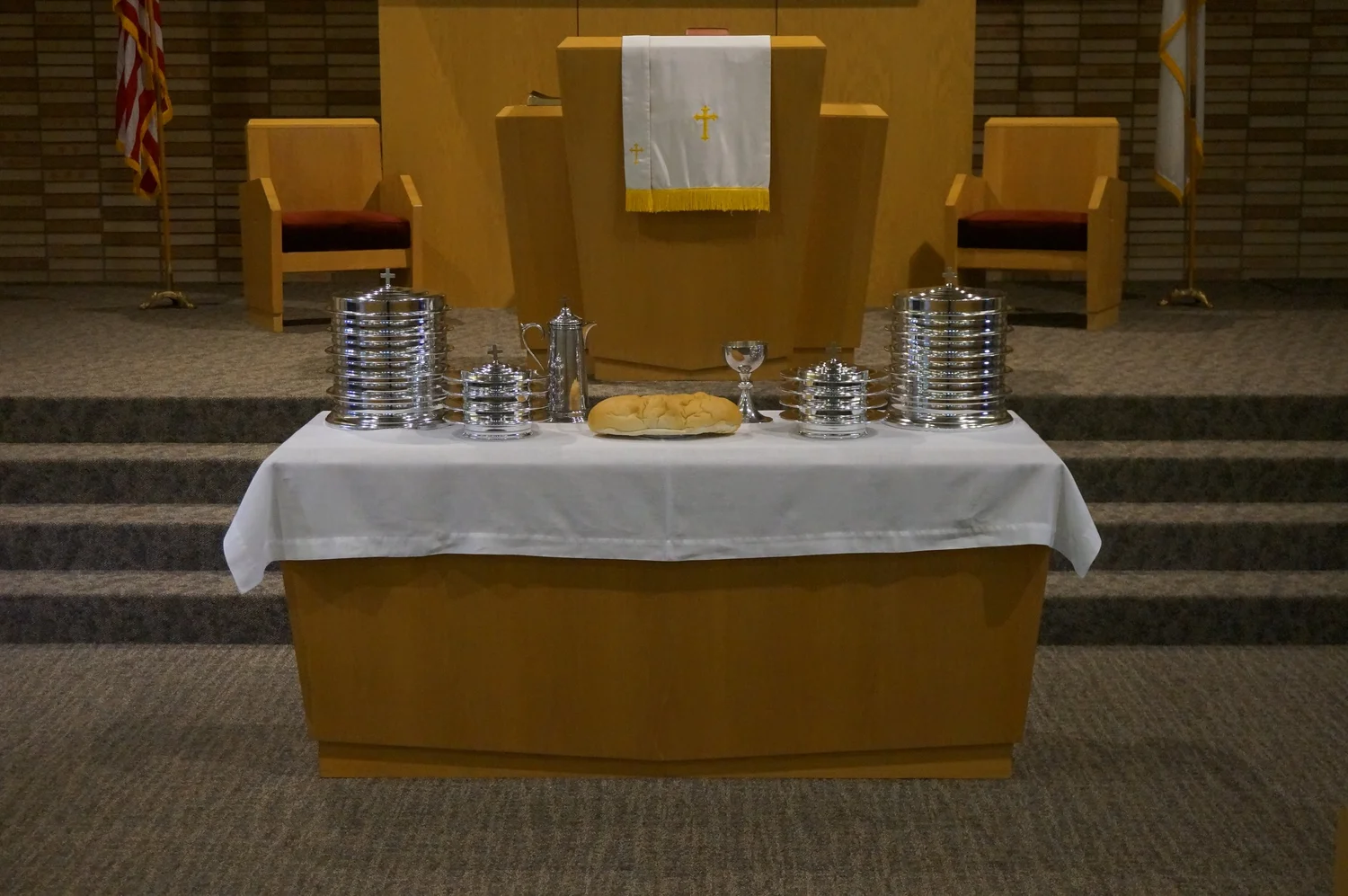 The communion table set with bread and the cup in front of the pulpit at First Reformed