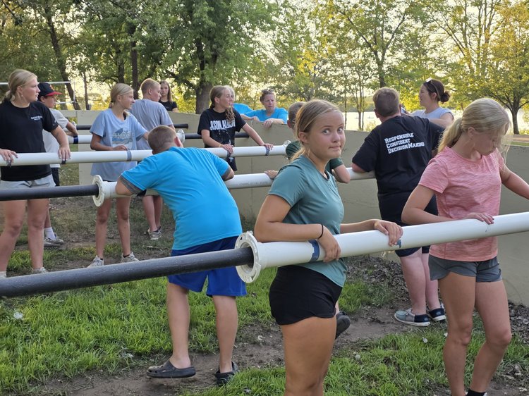 Students playing a game of human foosball outdoors