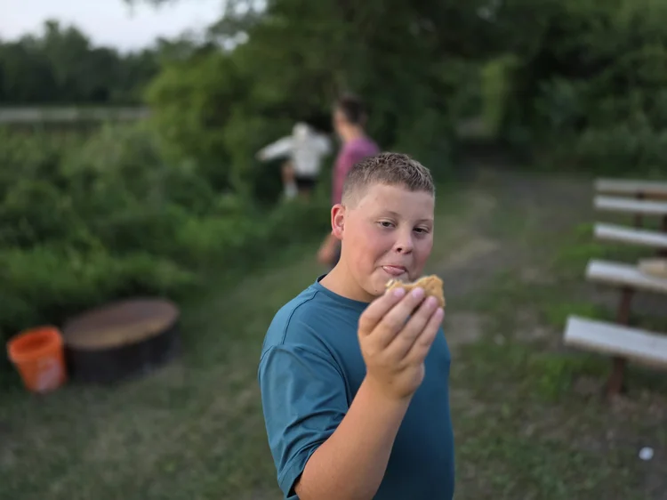 A student taking a bite of a s