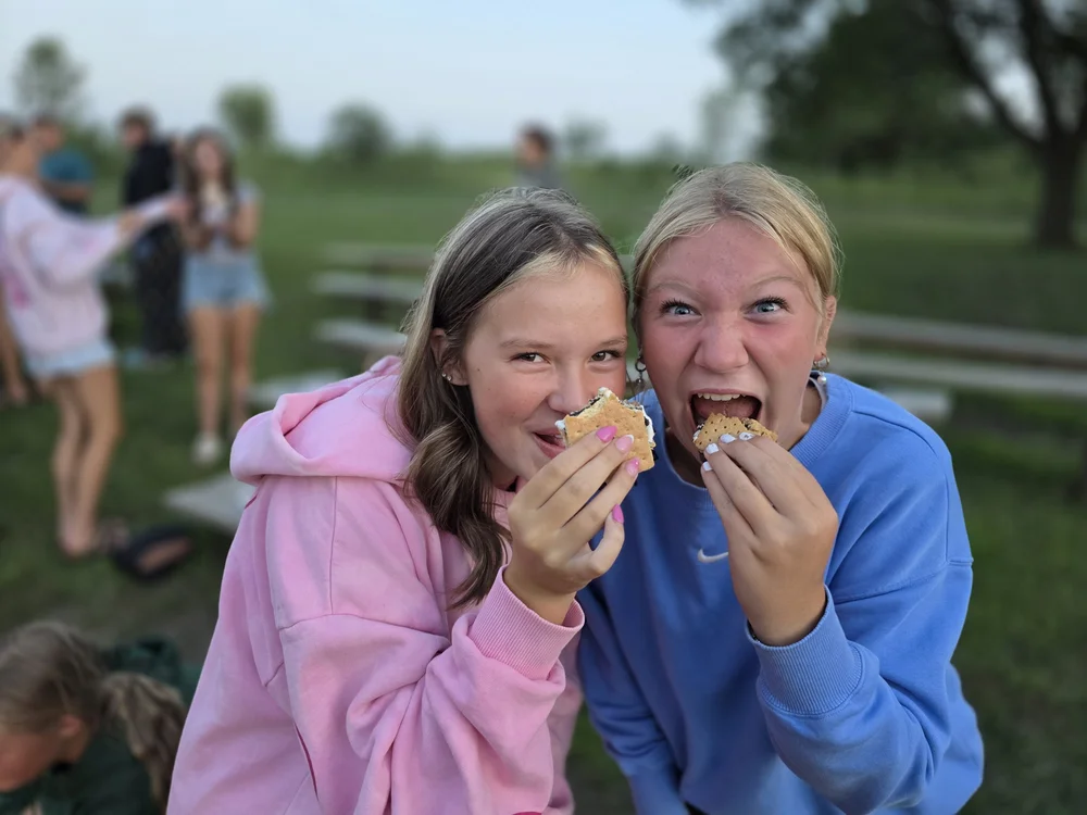 Two students enjoying s’mores at Catechism Camp