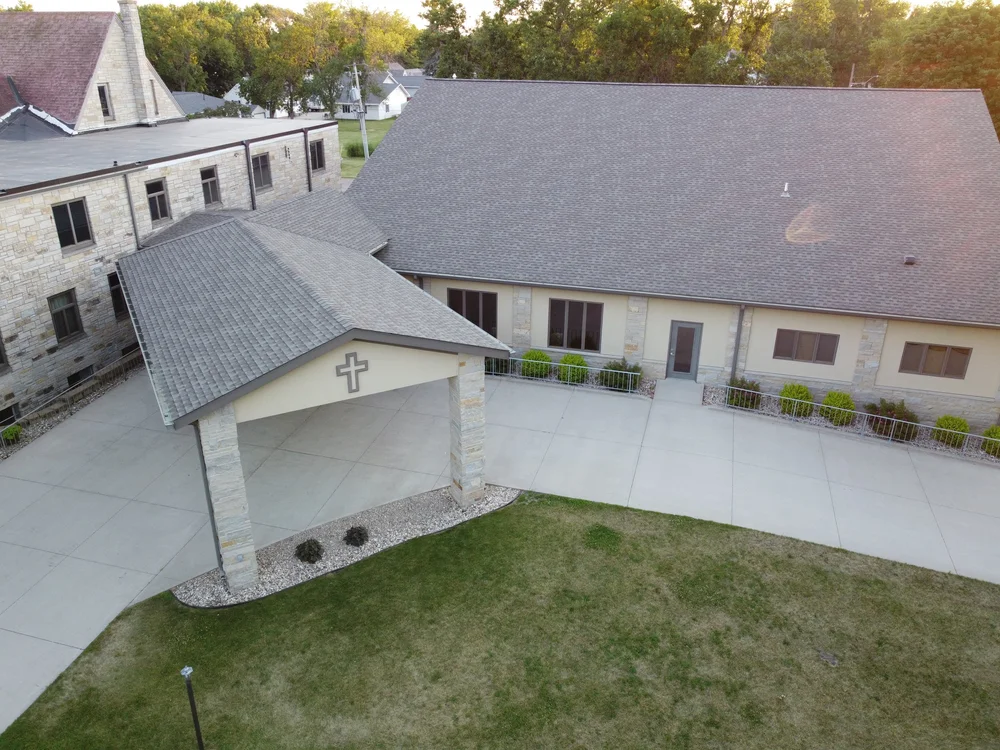 Aerial view of the covered entrance with a cross on the canopy at First Reformed Church