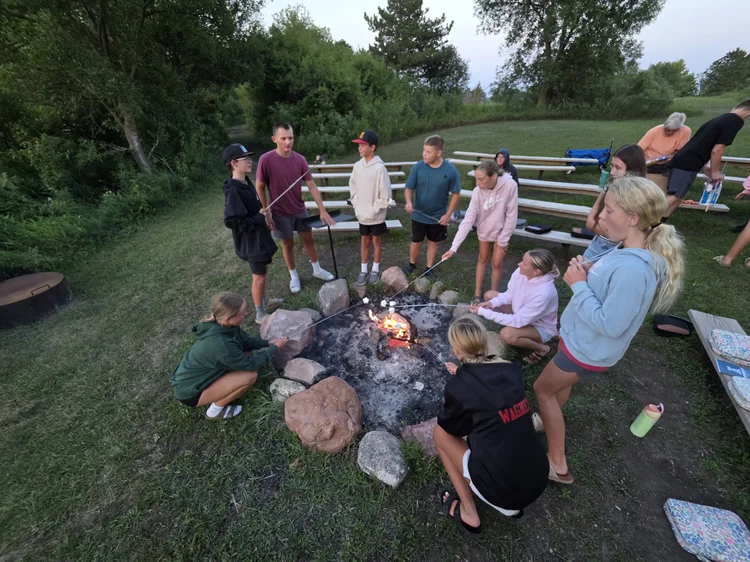 Students gathered around a campfire