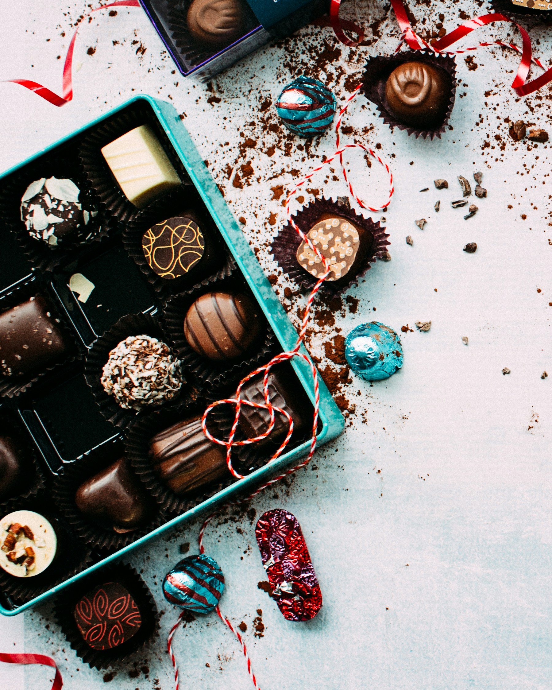 Chocolate truffles in a teal metal tin