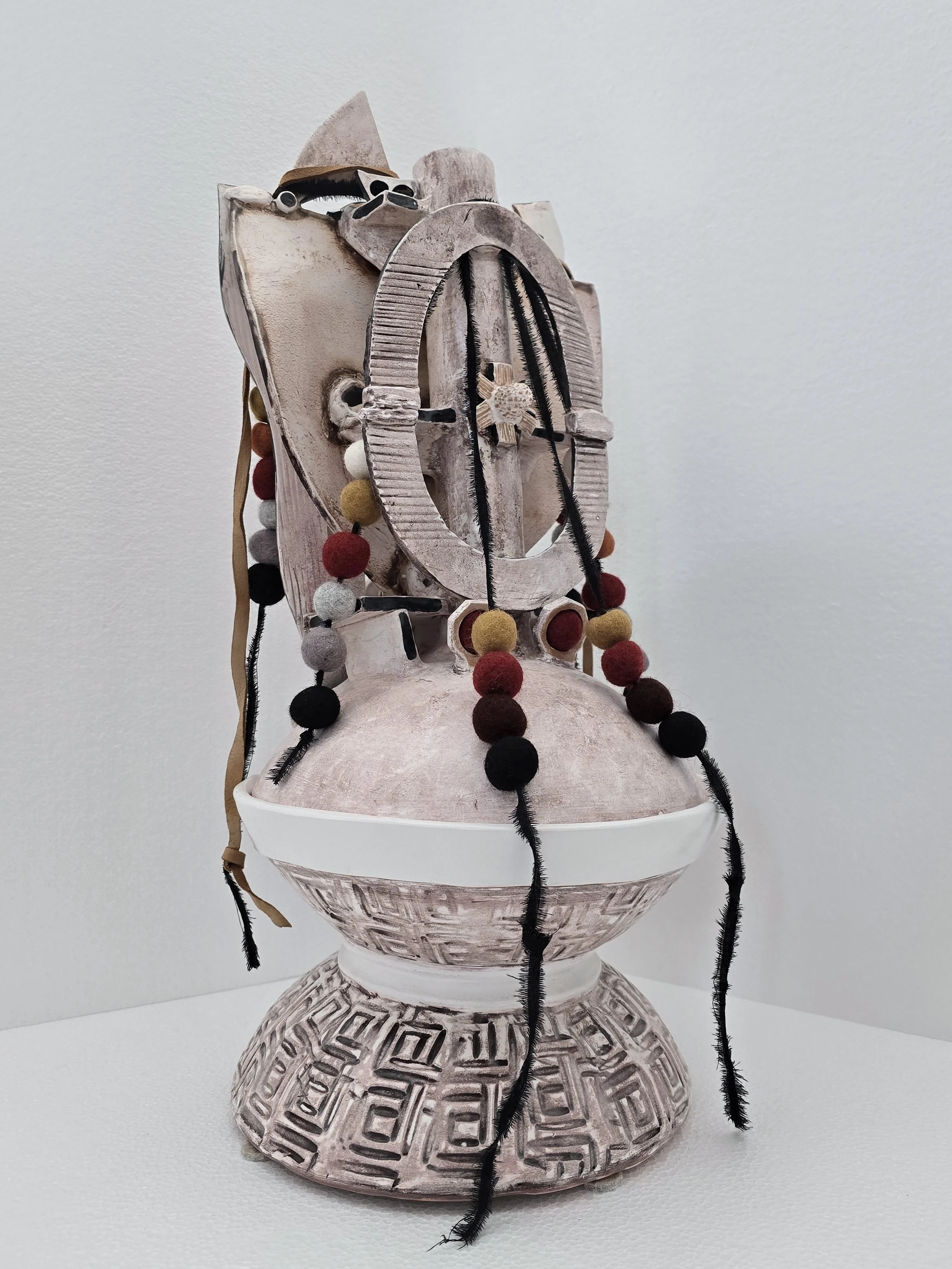 Metamorphosis, 2025, 21.5 x 9.5 in.., porcelain, cotton, wool, leather (back)