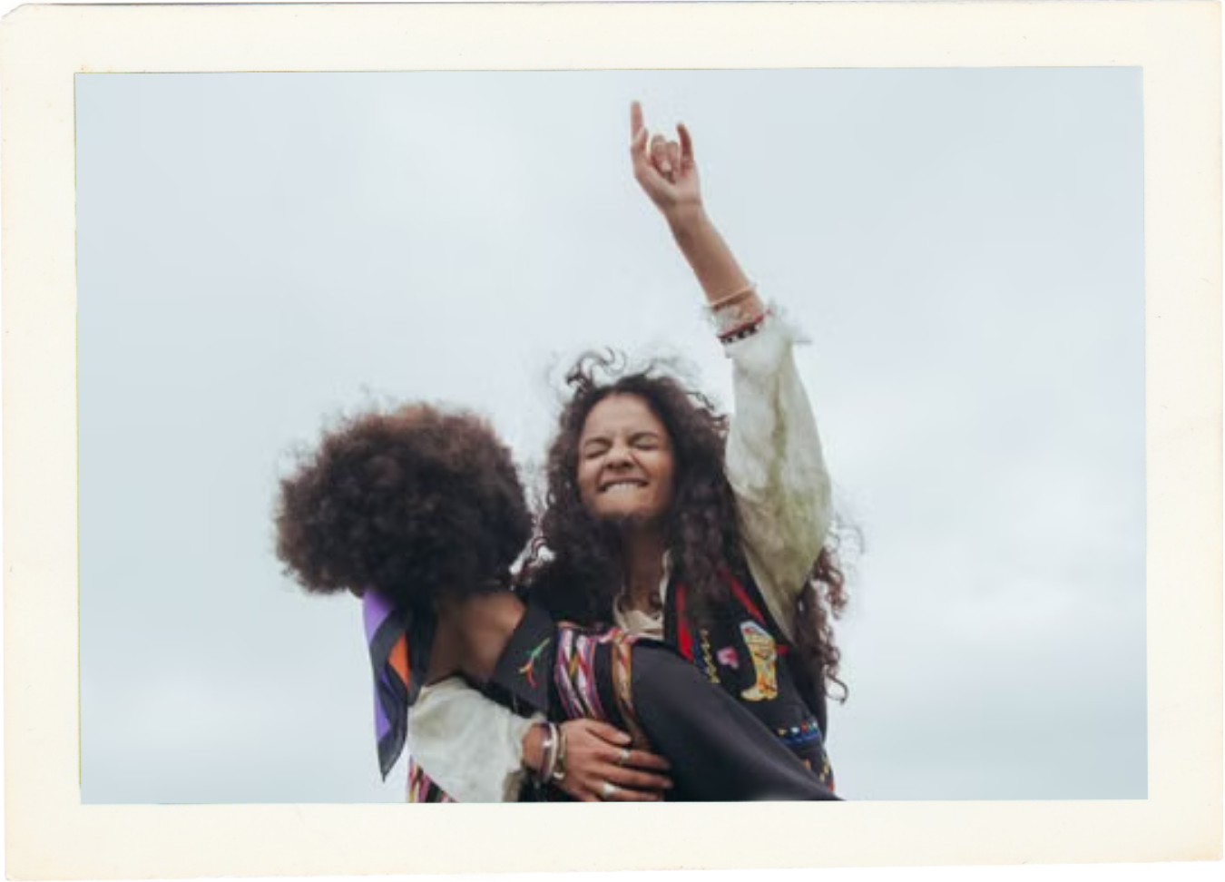 Woman riding piggyback on a friend outdoors.