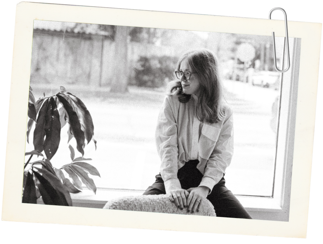 Haleigh Culverhouse, founder and therapist at Human to the Fullest, sitting beside a large window.