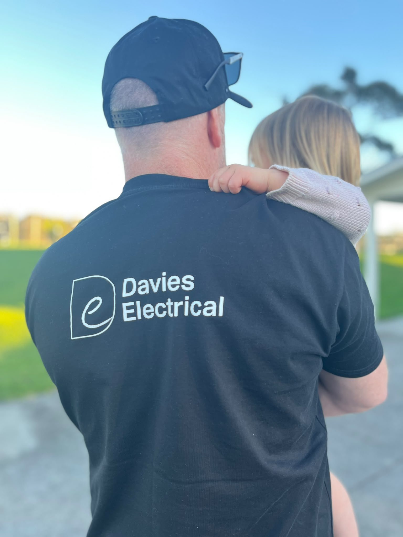 Tony from Davies Electrical (featured carrying his daughter) is an experienced electrician - this family business is proud to be local