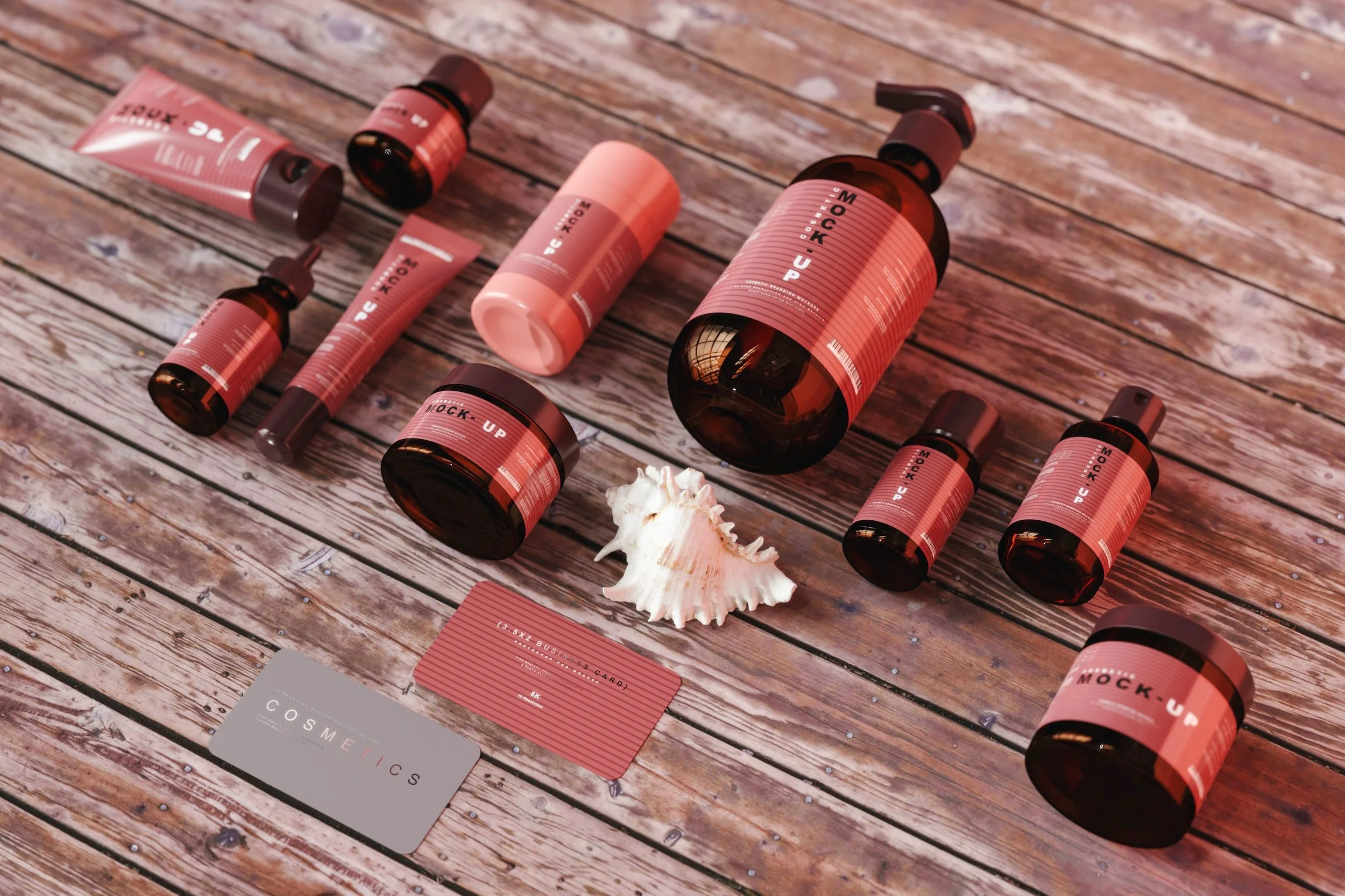 Several skincare products including bottles and tubes with pink labels, a seashell, and cosmetic cards lying on a wooden surface.