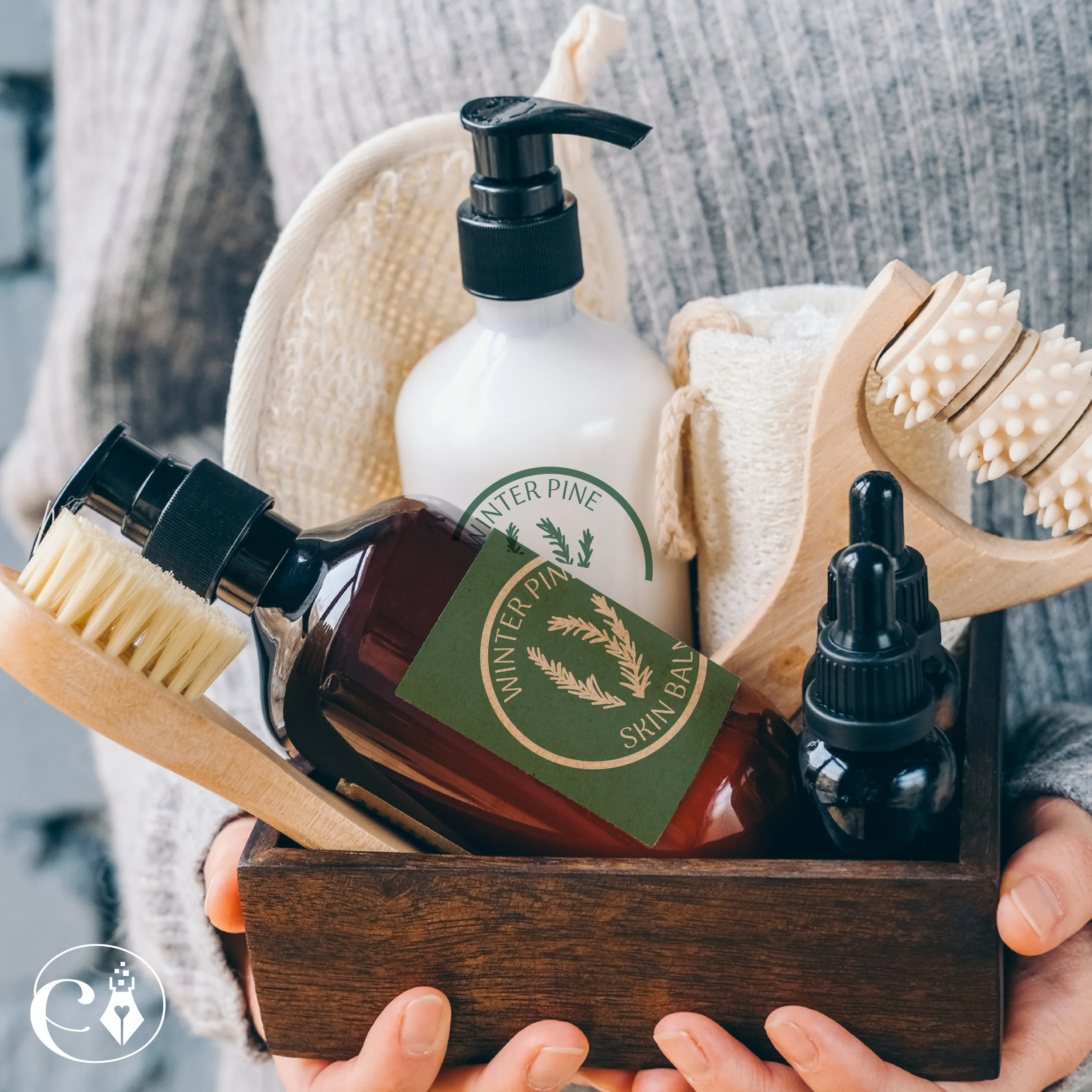 Close-up of a person's hands holding a wooden tray with natural skincare products including a white bottle with a black pump, a dark brown bottle with a black pump, a wooden comb, and a textured wooden massager with white beads.