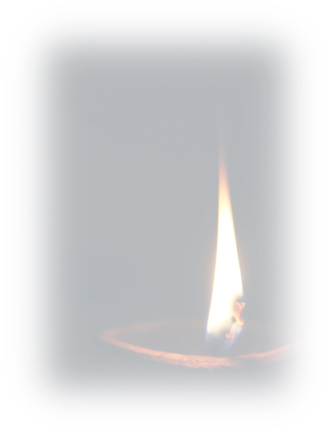 A single candle flame burning against a dark background.