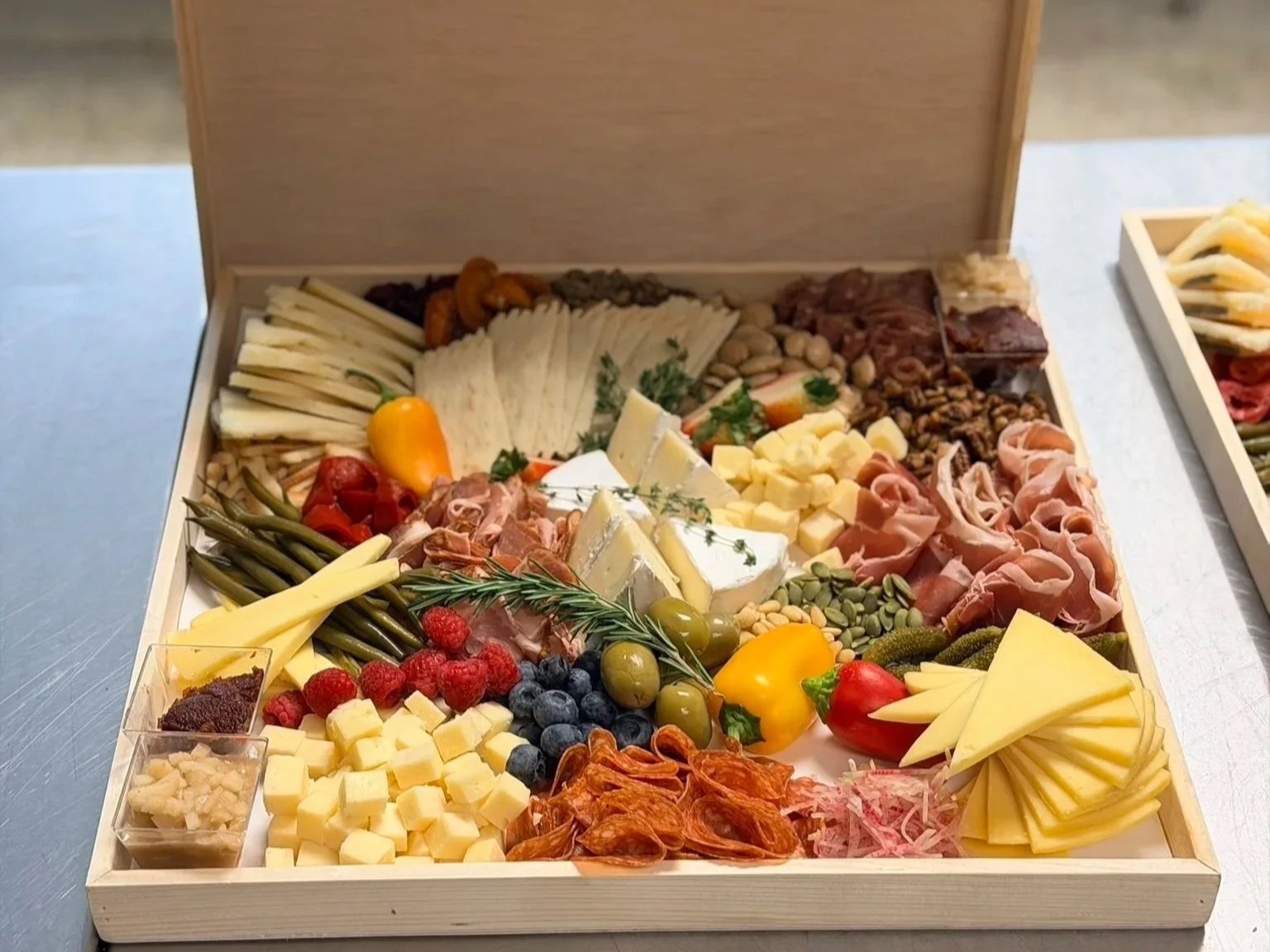 A chef-prepared cheese board for a corporate office luncheon