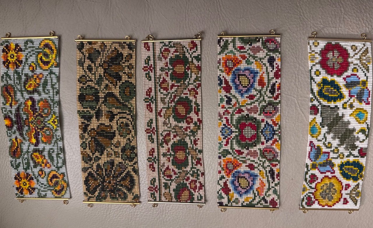 Close-up of beaded bracelets by Irene Stone Gerdans. Inspired by ancient Ukrainian and European ornamentation, these pieces bridge tradition and contemporary artistic expression. Some patterns are traditional and are based on ceremonial necklaces sym