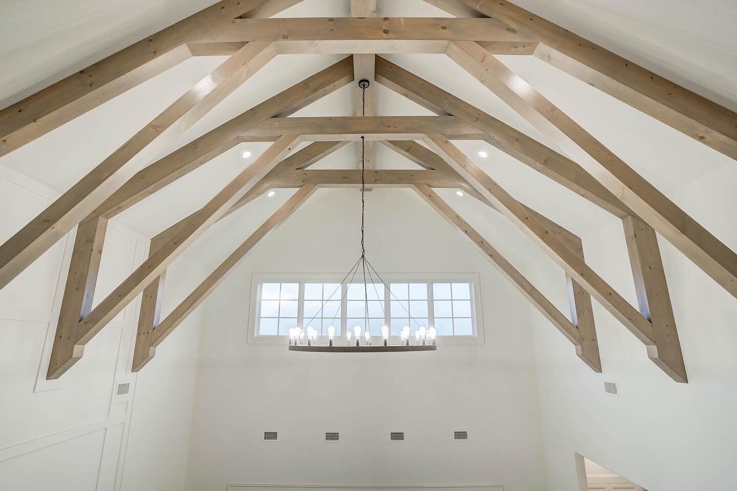 We worked with inspiration images of a gambrel roof + beamwork that followed the framing of the roof line. Although this home didn't have a gambrel roof, we created a custom beam pattern to imitate the feel of the gambrel.