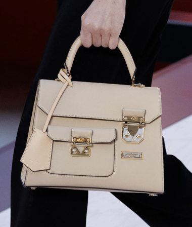 LINNETTE shows an image of a white designer handbag with two buckles
