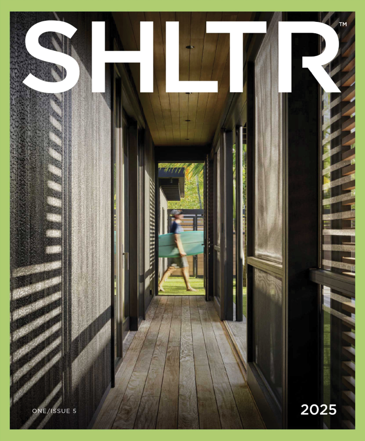 A cover of a magazine titled 'SHLTR,' showing a narrow outdoor walkway with wooden flooring and siding, leading to a person carrying a surfboard outside, with the year 2025 and issue number 5 noted.
