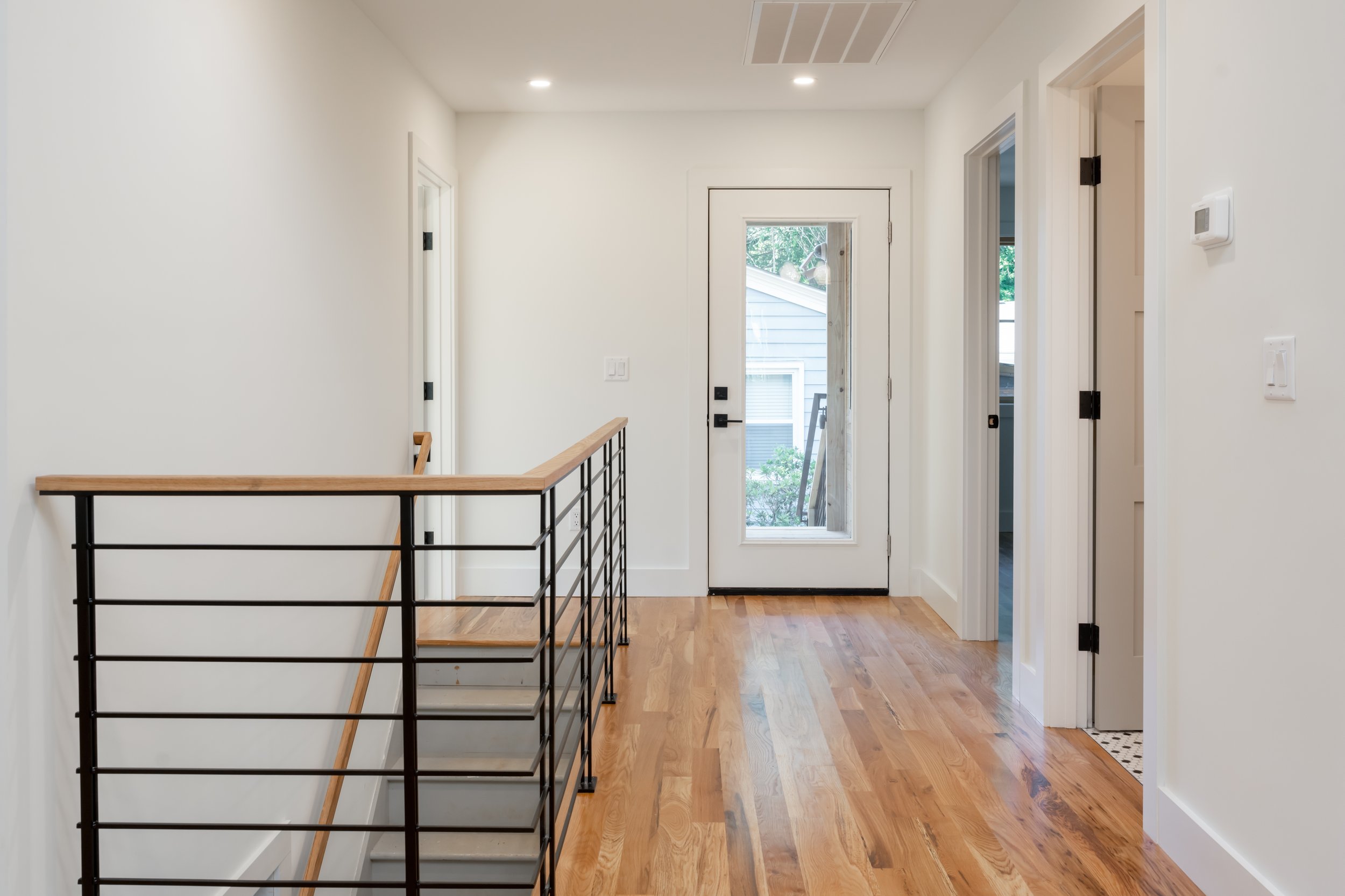Construction by Lobo Builders - Photo by Ryan Theede Photography - Asheville Interior Design - Modern Bungalow - Kitchen Renovation - Custom Steel Staircase