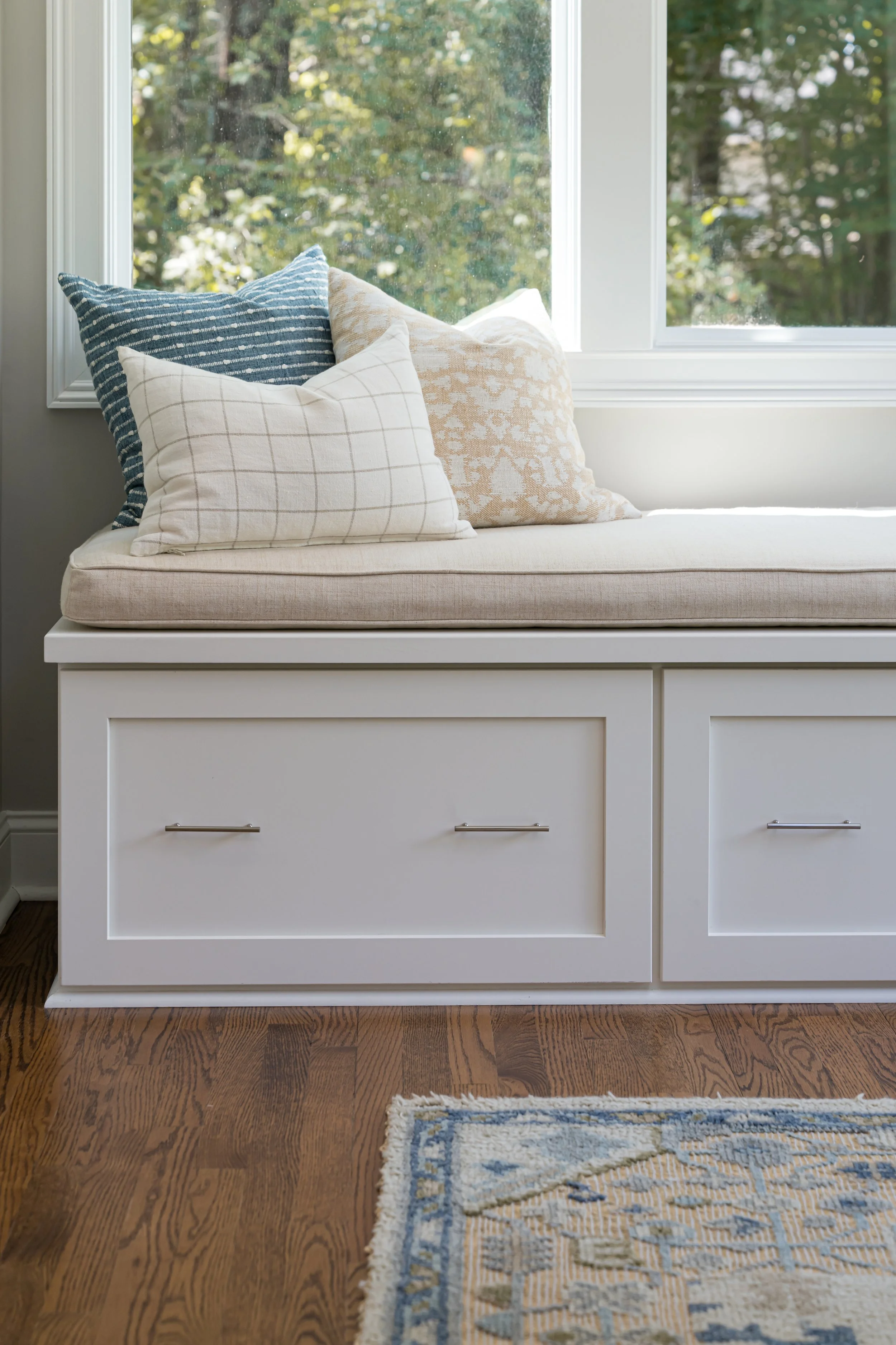 Photo by Ryan Theede Photography - Asheville Interior Design; Classic meets modern sunroom with custom built-in bench