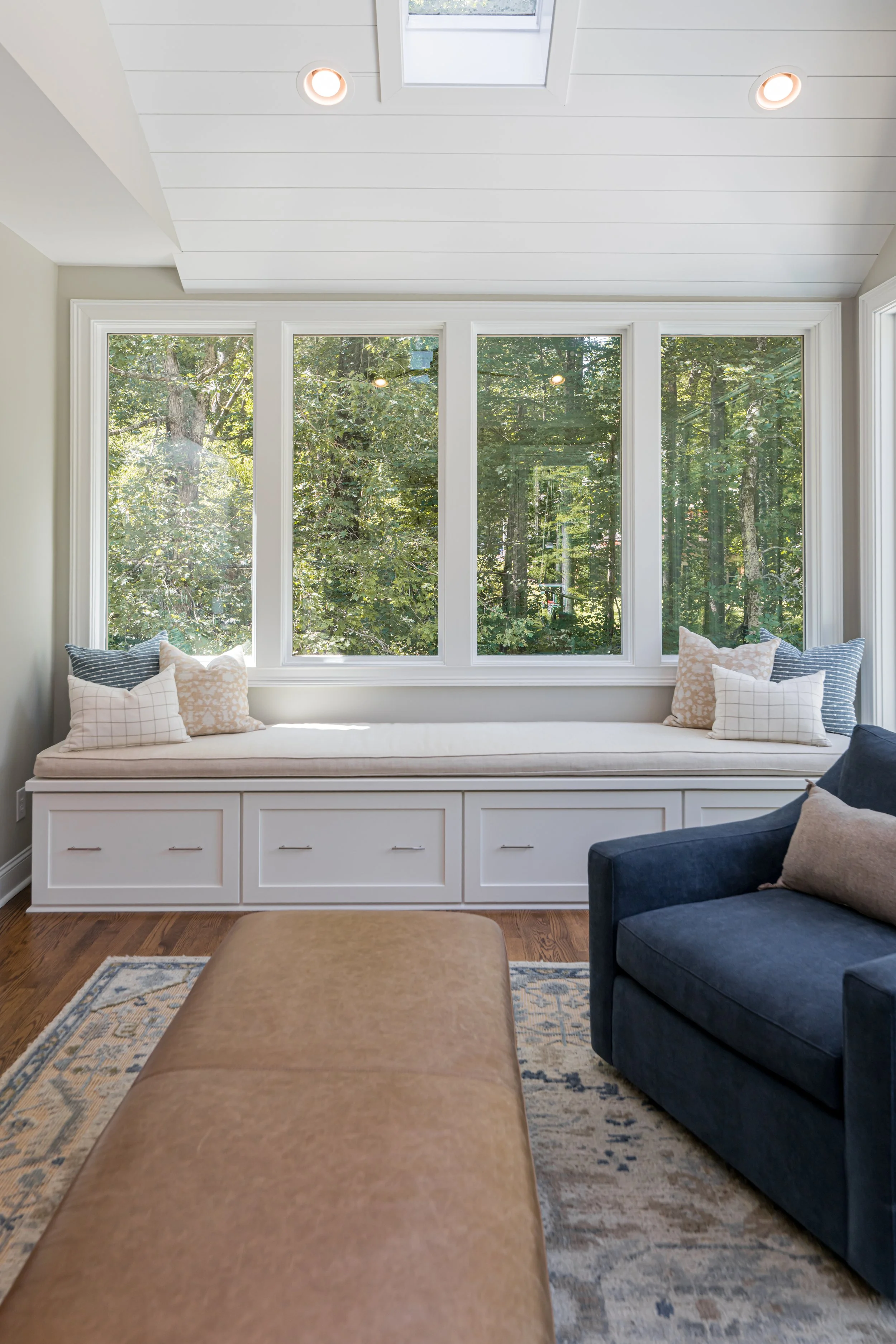 Photo by Ryan Theede Photography - Asheville Interior Design; Classic meets modern sunroom with custom built-in bench