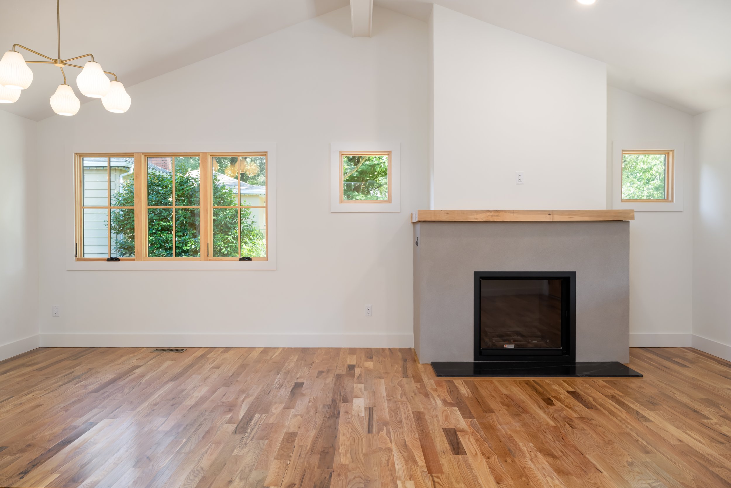 Construction by Lobo Builders - Photo by Ryan Theede Photography - Asheville Interior Design - Bungalow Renovation - Custom Fireplace + Beautiful Chandelier