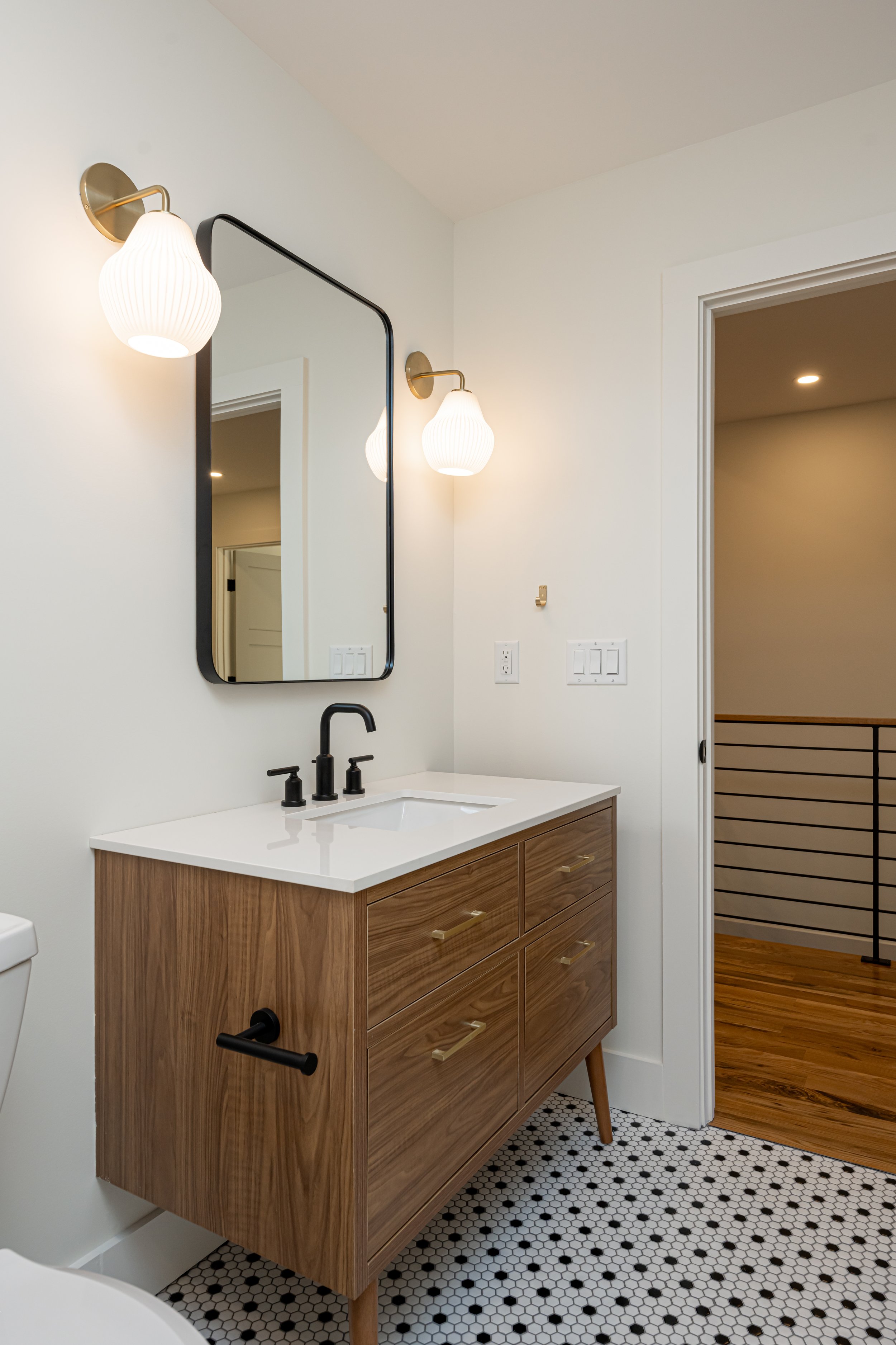 Construction by Lobo Builders - Photo by Ryan Theede Photography - Asheville Interior Design - Bungalow Renovation - Classic tile + Midcentury Bathroom Sconces