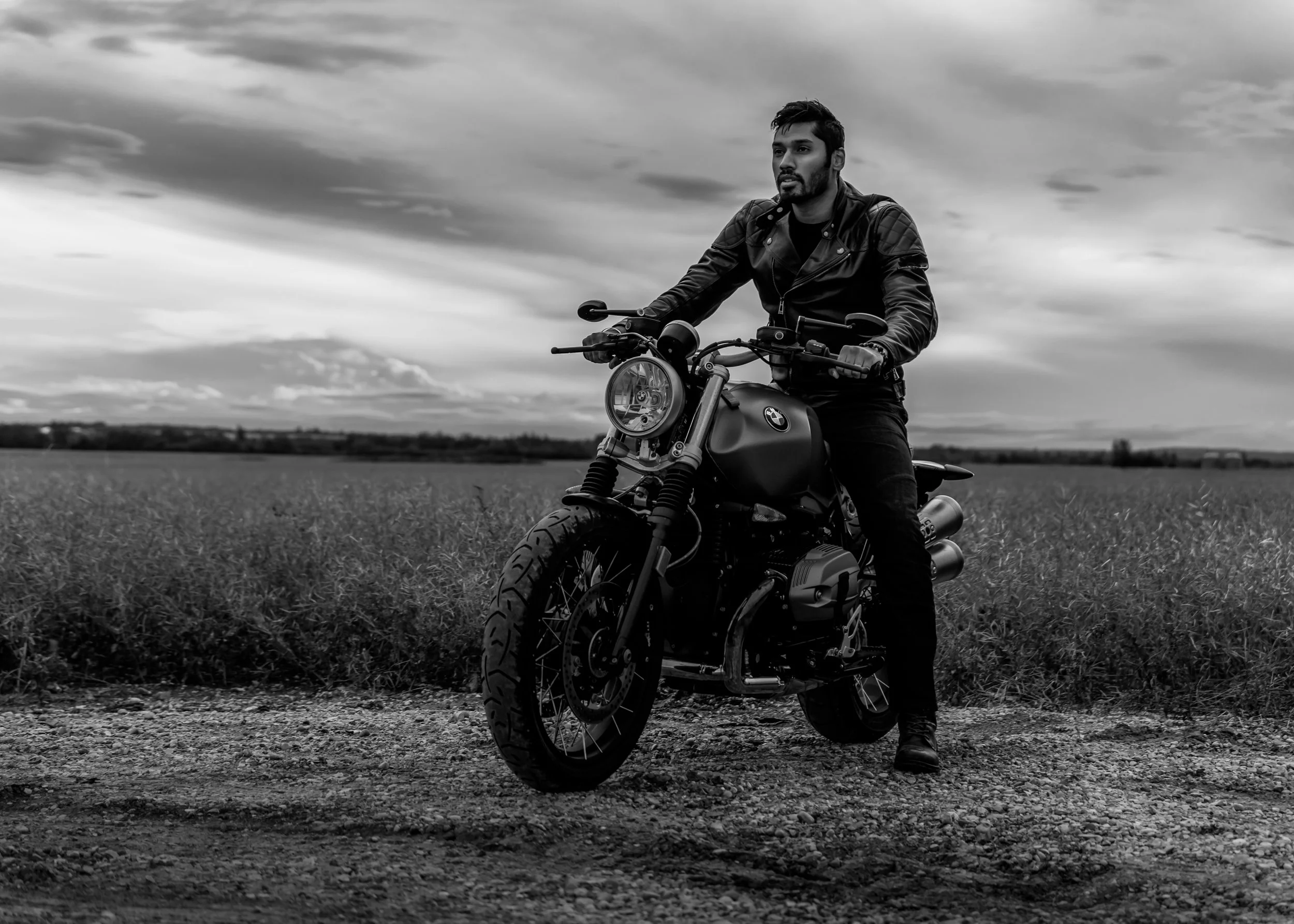 Black and white images of man on motorcycle in field | Edmonton motorcycle photographer DarkShark Media