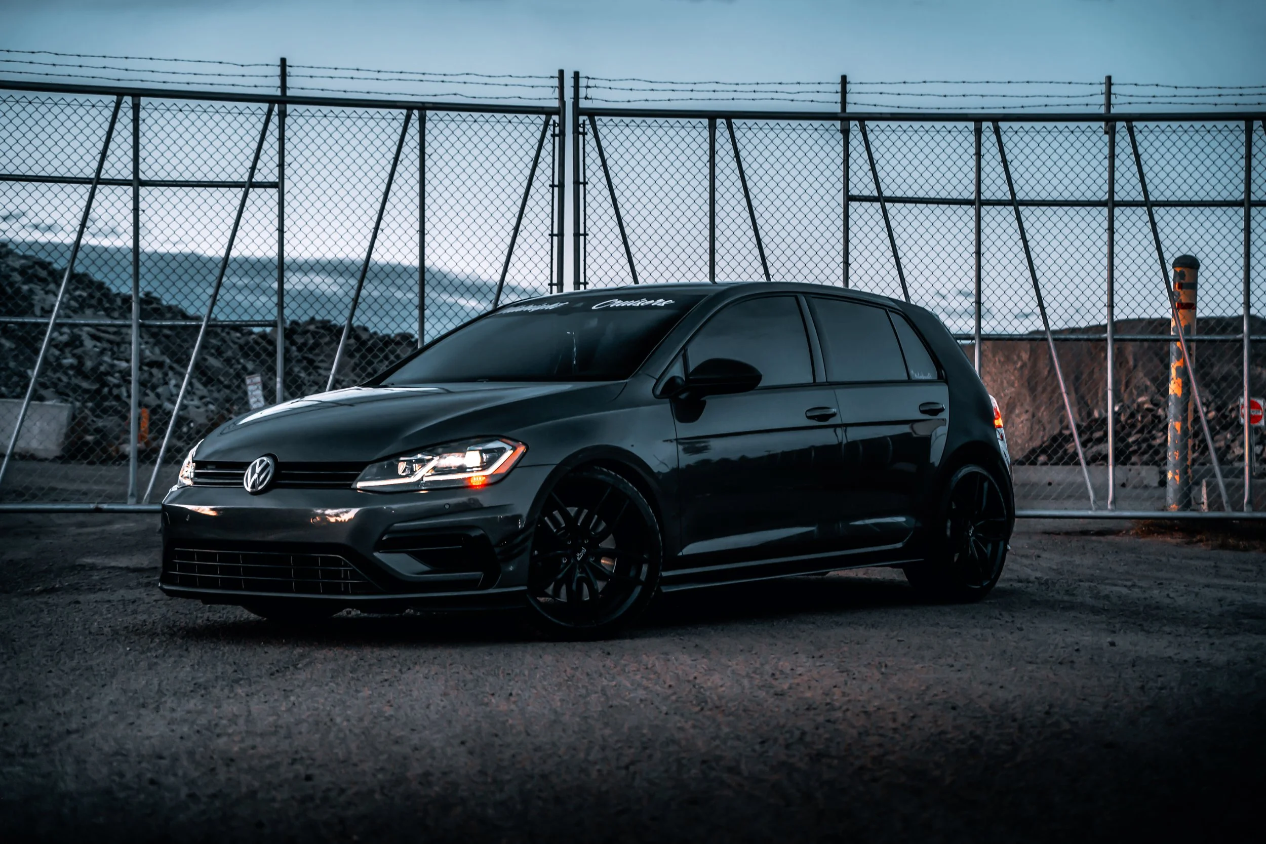 Black Volkswagen Golf parked in front of Gate | Edmonton automotive photographer DarkShark Media