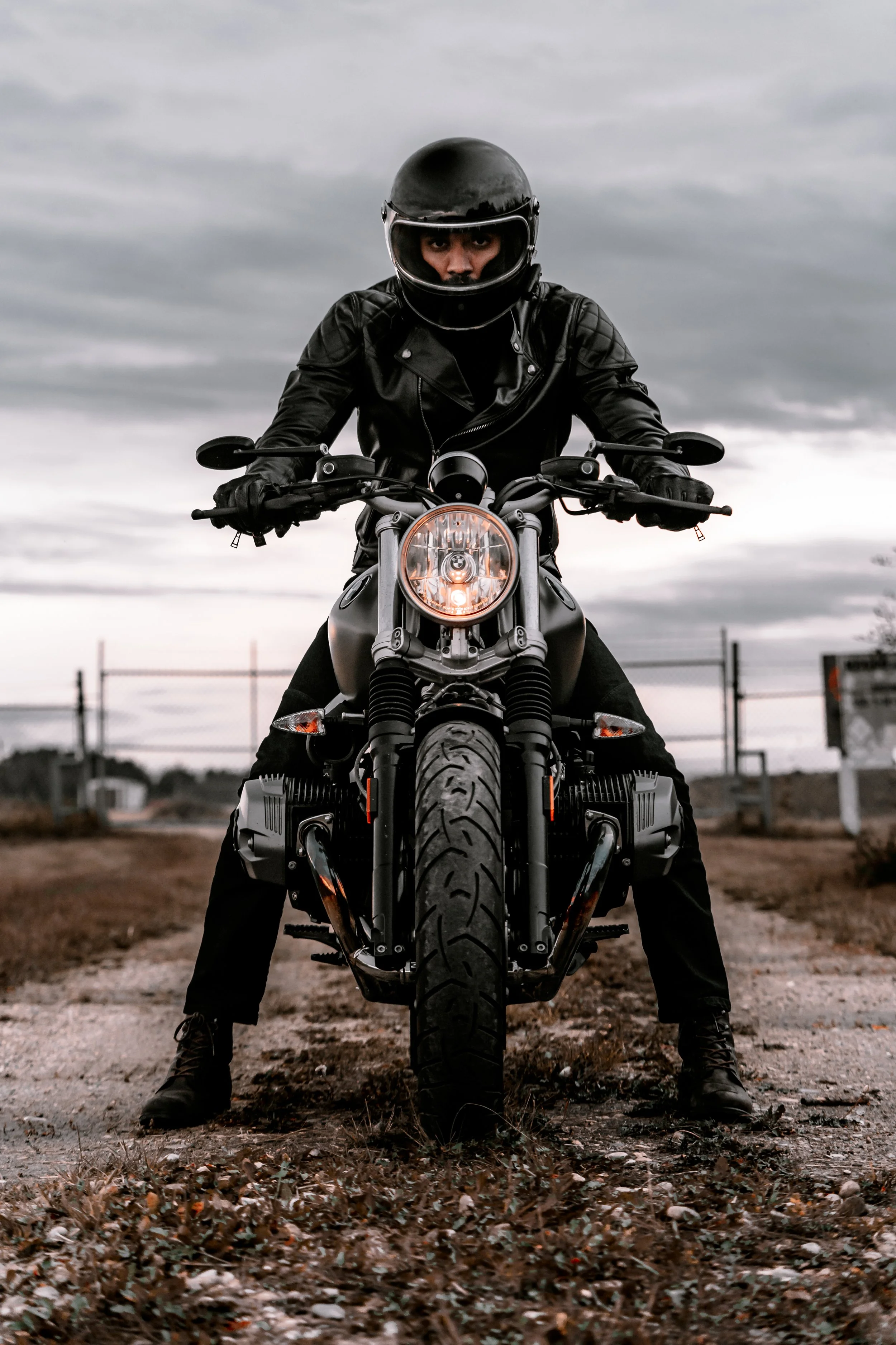 A rider in all black sits on BMW R Nine T motorycle | Edmonton motorcycle photographer DarkShark Media
