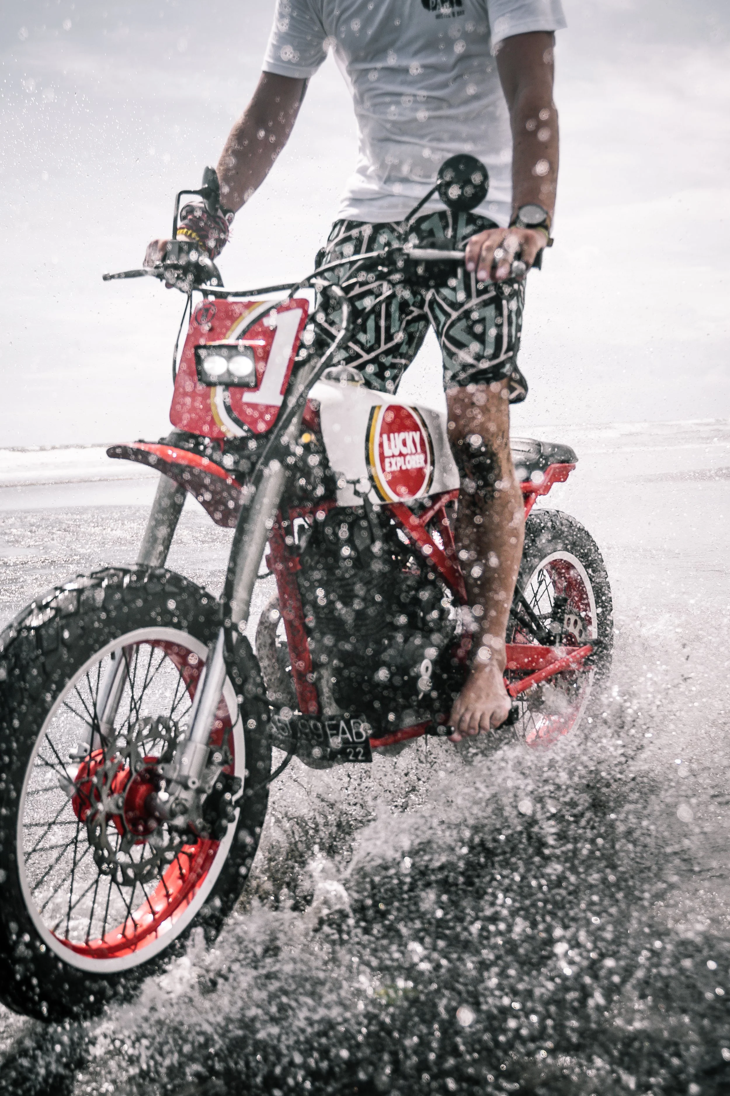 Man riding motorbike barefoot along the beach | Edmonton motorcycle photographer DarkShark Media