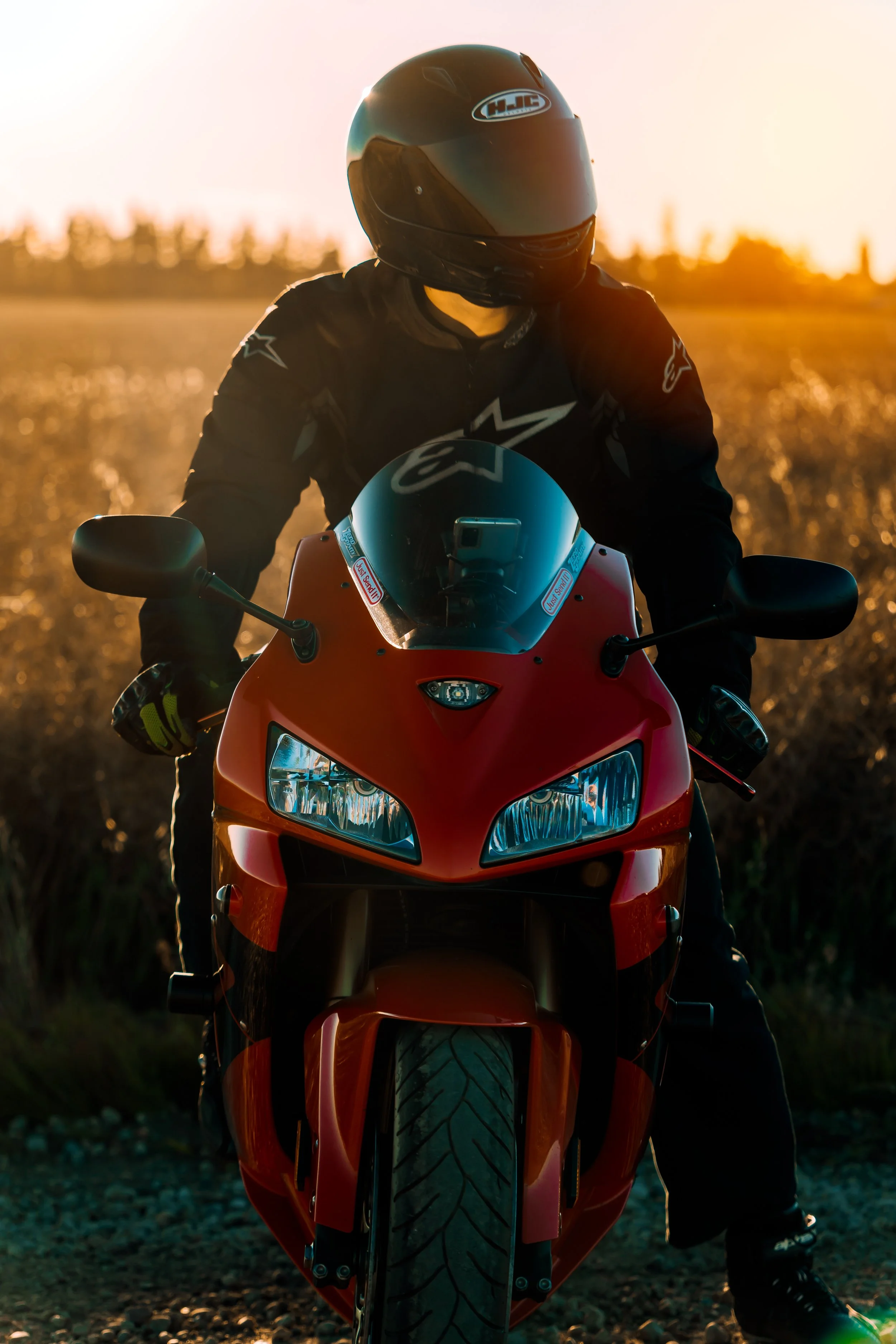 Motorbike rider in all black leathers poses on motorcycle | Edmonton motorcycle photographer DarkShark Media